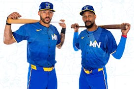 Twins shortstop Carlos Correa and center fielder Byron Buxton showcase the team's new City Connect uniforms, which feature only the letters MN on the 
