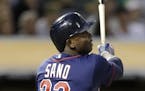 Minnesota Twins' Miguel Sano follows through on an RBI sacrifice fly off Oakland Athletics Tyler Clippard during the ninth inning of a baseball game S