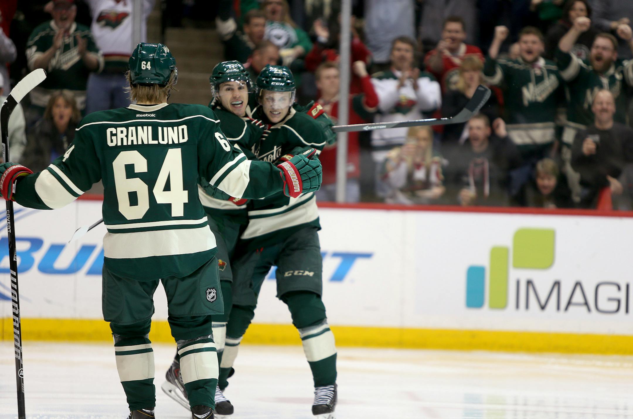 Minnesota's Zach Parise, center, celebrated his winning goal with teammates Mikael Granlund, left, and Jonas Brodin, right, during the third period as the Wild took on the New York Rangers at the Xcel Energy Center, Thursday, March 13, 1014 in St. Paul, MN. ] (ELIZABETH FLORES/STAR TRIBUNE) ELIZABETH FLORES • eflores@startribune.com
