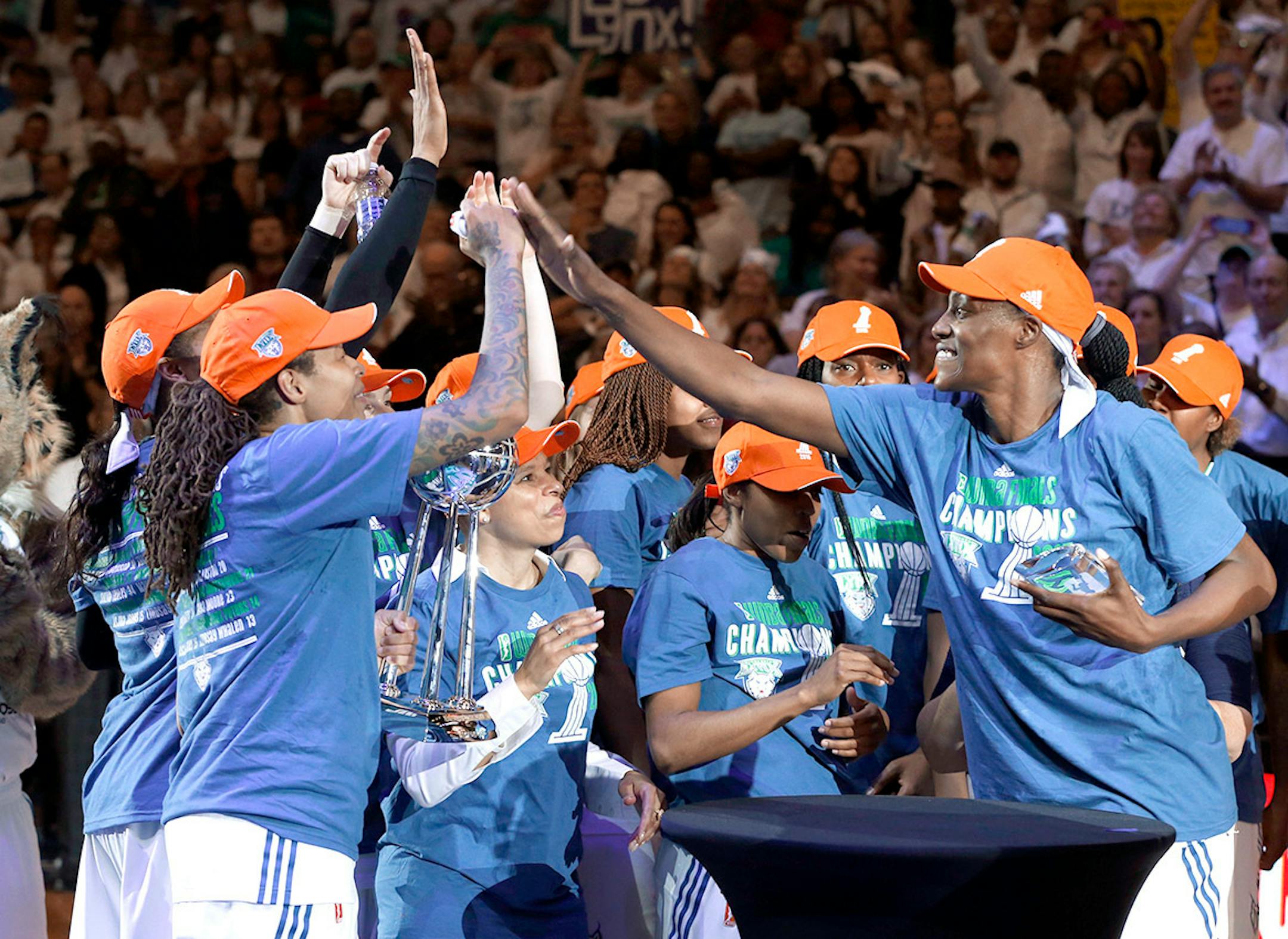 Minnesota Lynx center Sylvia Fowles, right, named most valuable player celebrates after beating the Indiana Fever 69-52 in Game 5 of the WNBA basketball finals, Wednesday, Oct. 14, 2015, in Minneapolis.