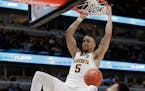 Amir Coffey dunks over Penn State's Lamar Stevens during the second half, one in which Coffey willed the Gophers to overtime and a victory