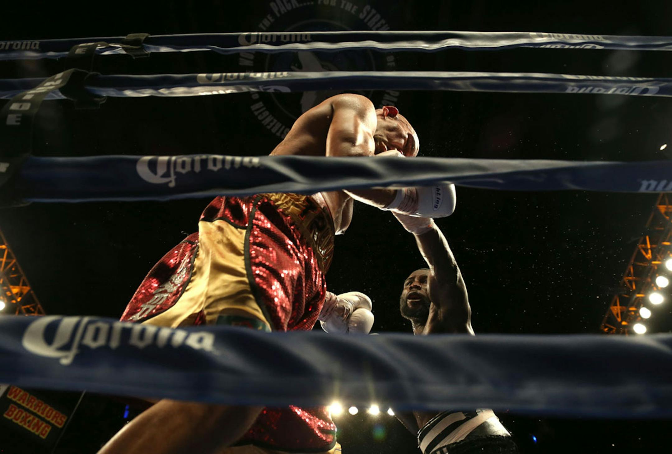 Ossie Duran aka - The Ghanaian Gladiator landed a left jab hook to the jaw of USBA Middleweight Champion Caleb Truax, of Osseo, Minnesotaduring a semi final fight at Target Center in Minneapolis Friday, January 3, 2014. The bout ended in a tie 95-95. ] (KYNDELL HARKNESS/STAR TRIBUNE) kyndell.harkness@startribune.com