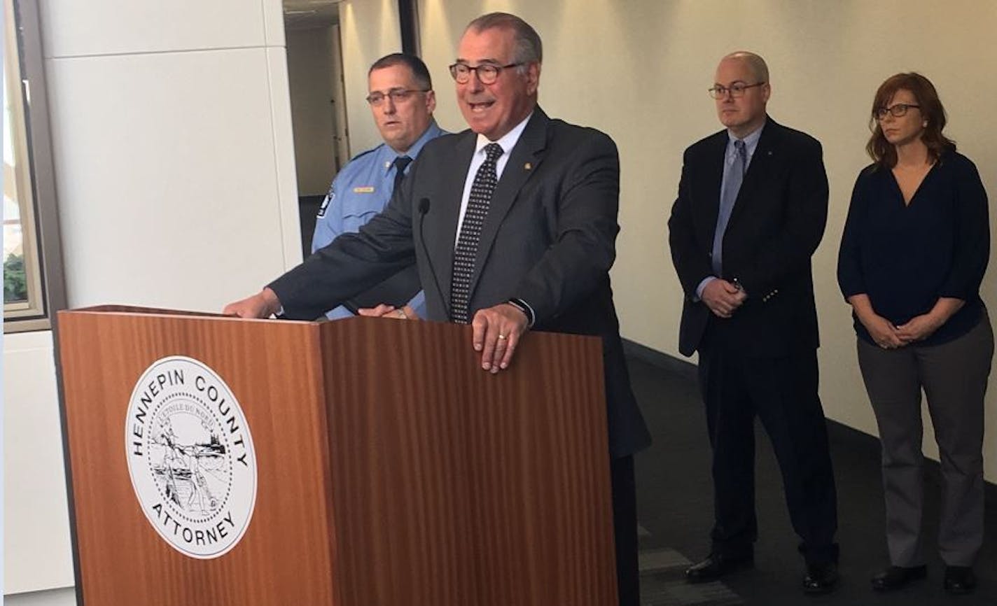 Police Cmdr. Bruce Folkens flanked Hennepin County Attorney Mike Freeman during a news conference Monday about a suspected serial rapist.