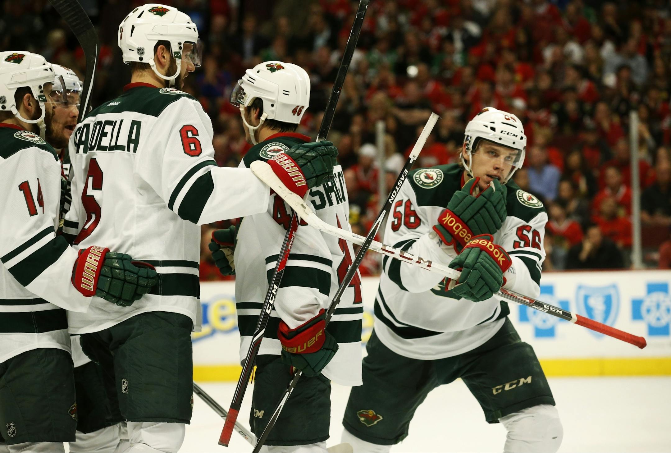 Minnesota Wild players celebrate left wing Erik Haula's (56)first period goal.