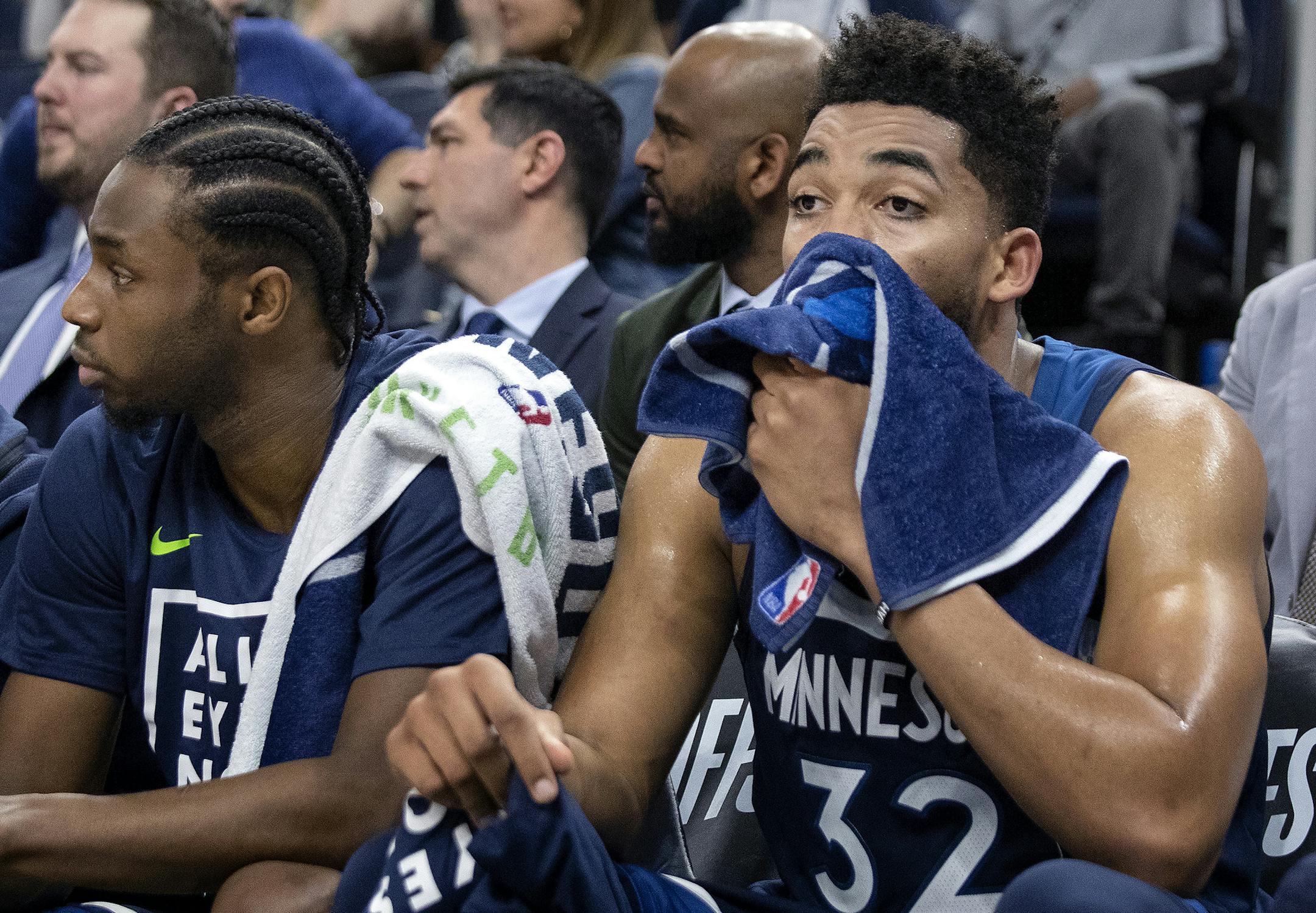 Minnesota Timberwolves' Andrew Wiggins (22) and Karl-Anthony Towns (32) watch from the bench in the final minute of the game against the Houston Rockets Monday, April 23, 2018 at the Target Center in Minneapolis, Minn. The Rockets won, (Carlos Gonzalez/Minneapolis Star Tribune/TNS) ORG XMIT: 1229363