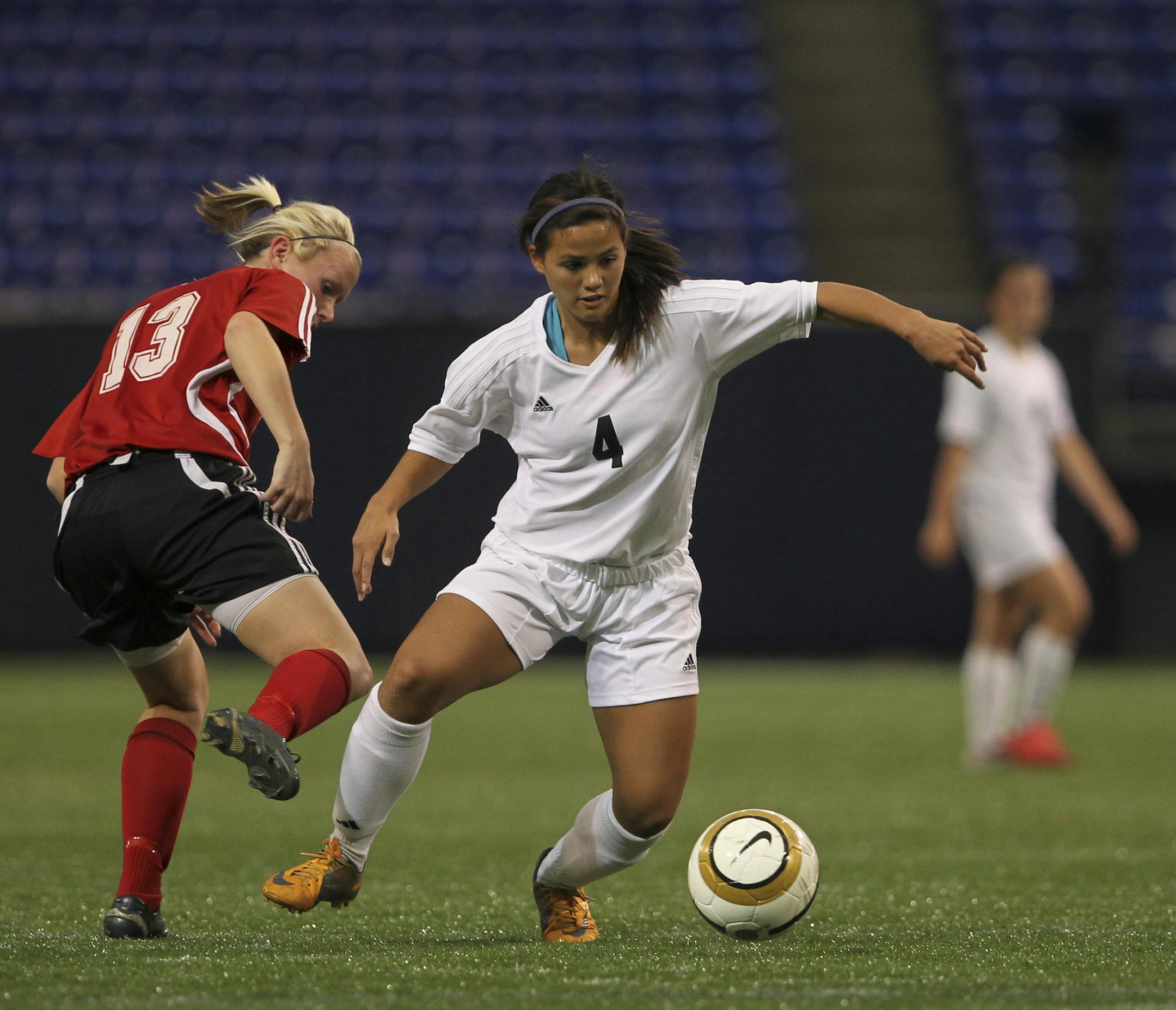 Burnsville's Alyssa Blahnik made a move on Centennial's Katie Lilja, left, to set up her first of three goals in the first half Monday. Burnsville held a 4-1 lead over Centennial after the first half when the two high schools met in the girls' Class AA soccer semi-final Monday afternoon, October 31, 2011 at the Metrodome in Minneapolis, Minn. ] JEFF WHEELER &#x201a;&#xc4;&#xa2; jeff.wheeler@startribune.com ORG XMIT: MIN2013080716003082