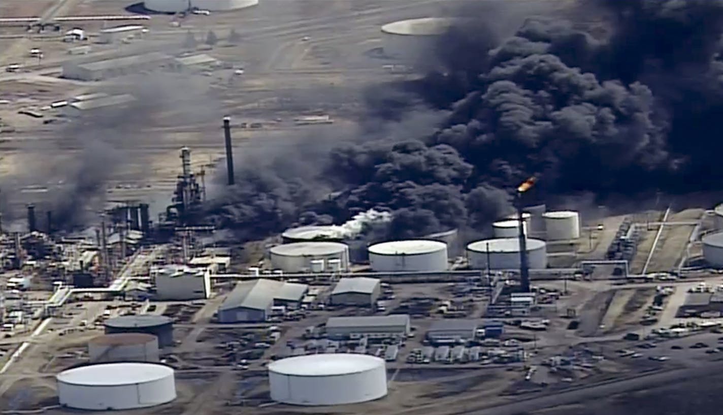 In this April 26, 2018, file frame from video smoke rises from the Husky Energy oil refinery after an explosion and fire at the plant in Superior, Wis. WDIO-TV reports Canada-based Husky Energy said in its second-quarter earnings statement Thursday, July 26, that the refinery in Superior, Wisconsin, is not expected to restart for at least 18 to 24 months. (KSTP-TV via AP, File)