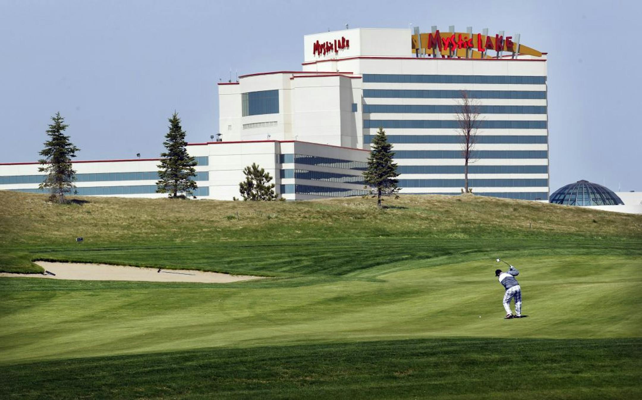 BRIAN PETERSON • brianp@startribune.com Prior Lake, MN - 5/4/2011 - A golfer at the Meadows Golf Course at Mystic Lake got in a few holes Wednesday afternoon with the Casino building in the background.