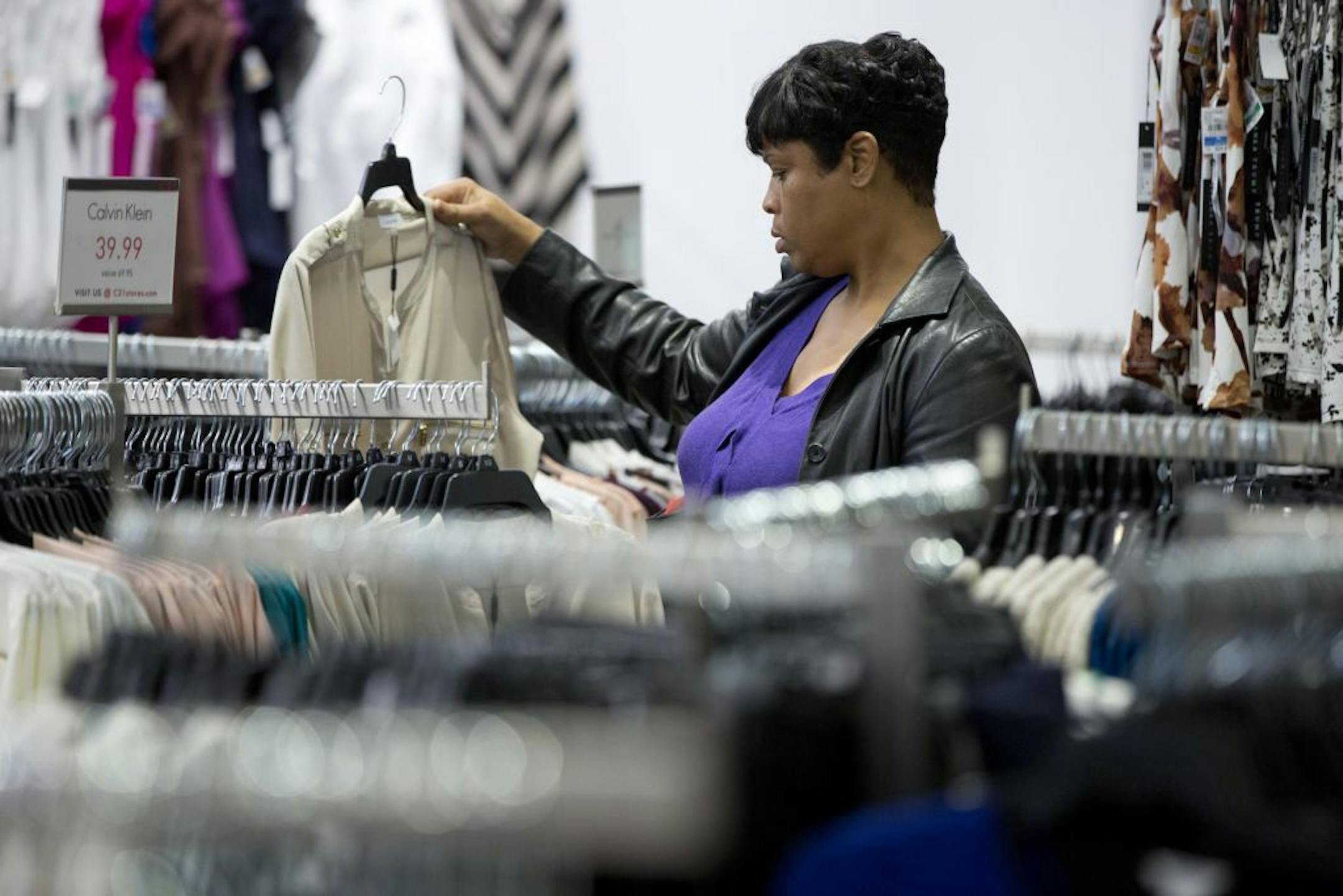 In this Oct. 28, 2014 photo, a woman shops at the Century 21 Department Store in Philadelphia. The Commerce Department releases retail sales data for October on Thursday, Dec. 11, 2014.