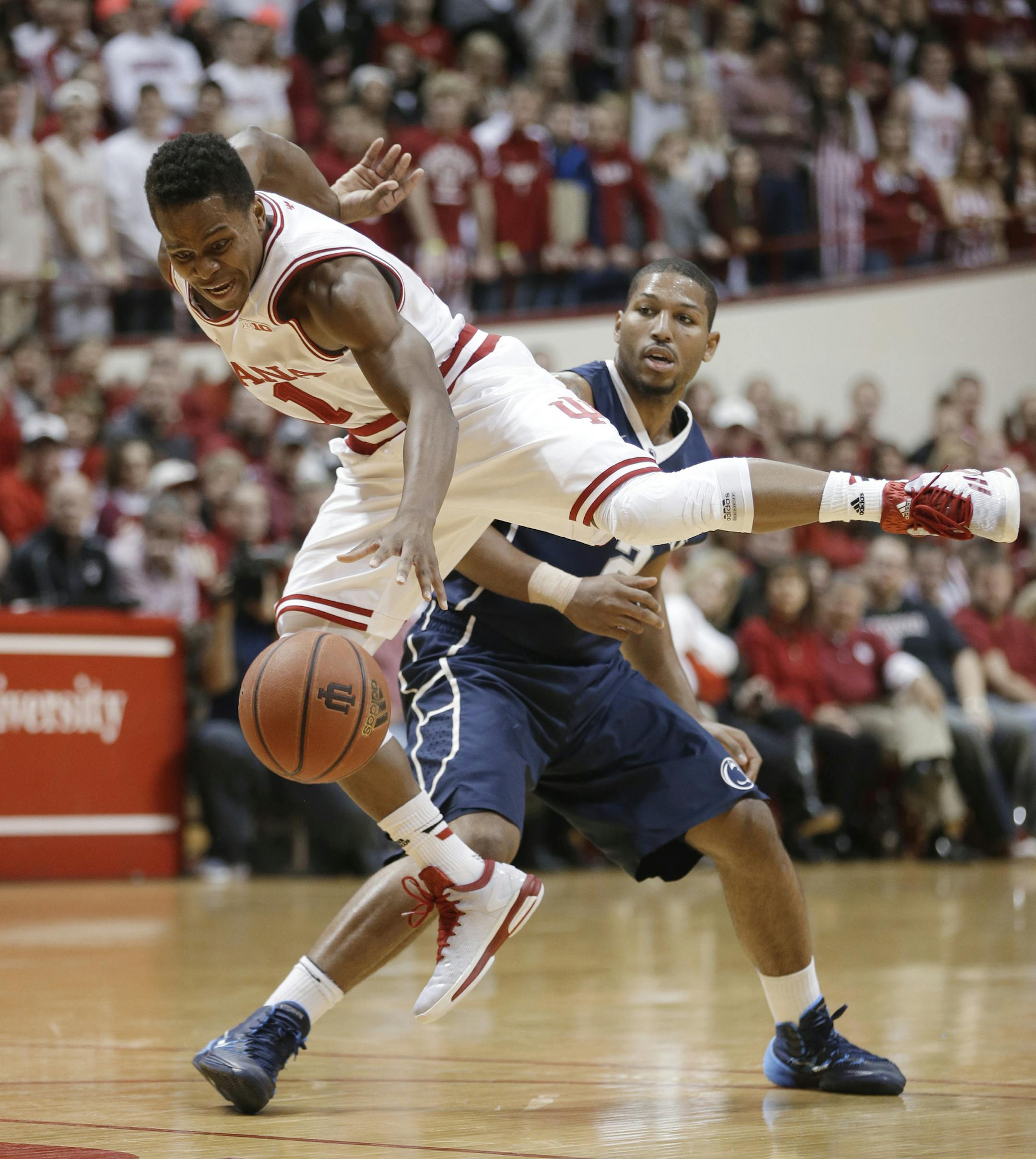 Indiana's Yogi Ferrell (11) is fouled by Penn State's D.J. Newbill (2) during the second half of an NCAA college basketball game Tuesday, Jan. 13, 2015, in Bloomington, Ind. Indiana won 76-73. (AP Photo/Darron Cummings)