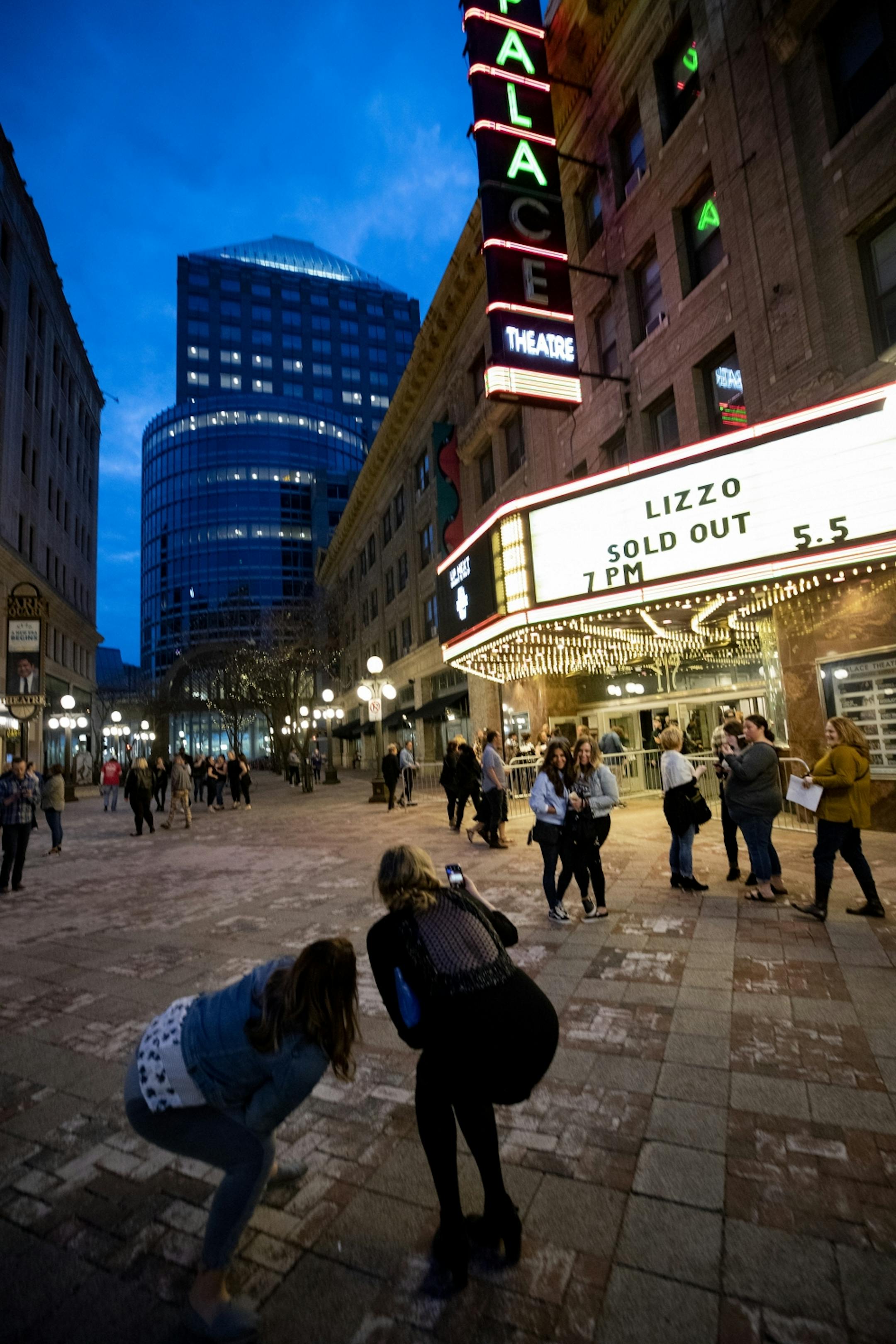Fans posed for photos outside of the Palace Theatre in St. Paul before a show by Lizzo.