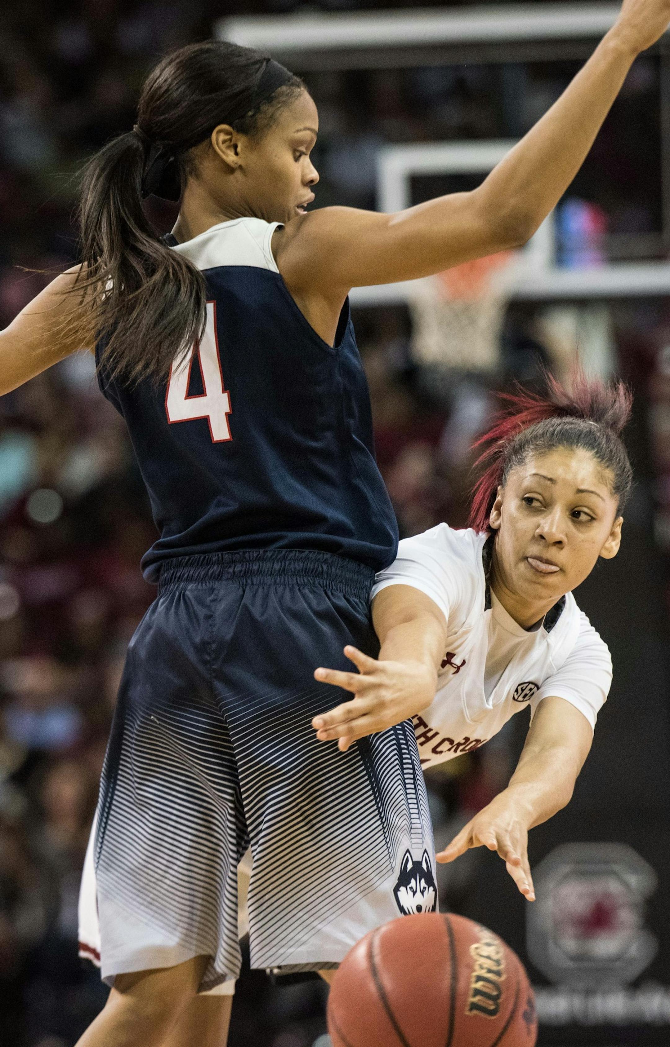 South Carolina guard Bianca Cuevas, right, passes to a teammate around Connecticut guard Moriah Jefferson during the first half of an NCAA college basketball game Monday, Feb. 8, 2016, in Columbia, S.C. (AP Photo/Sean Rayford)