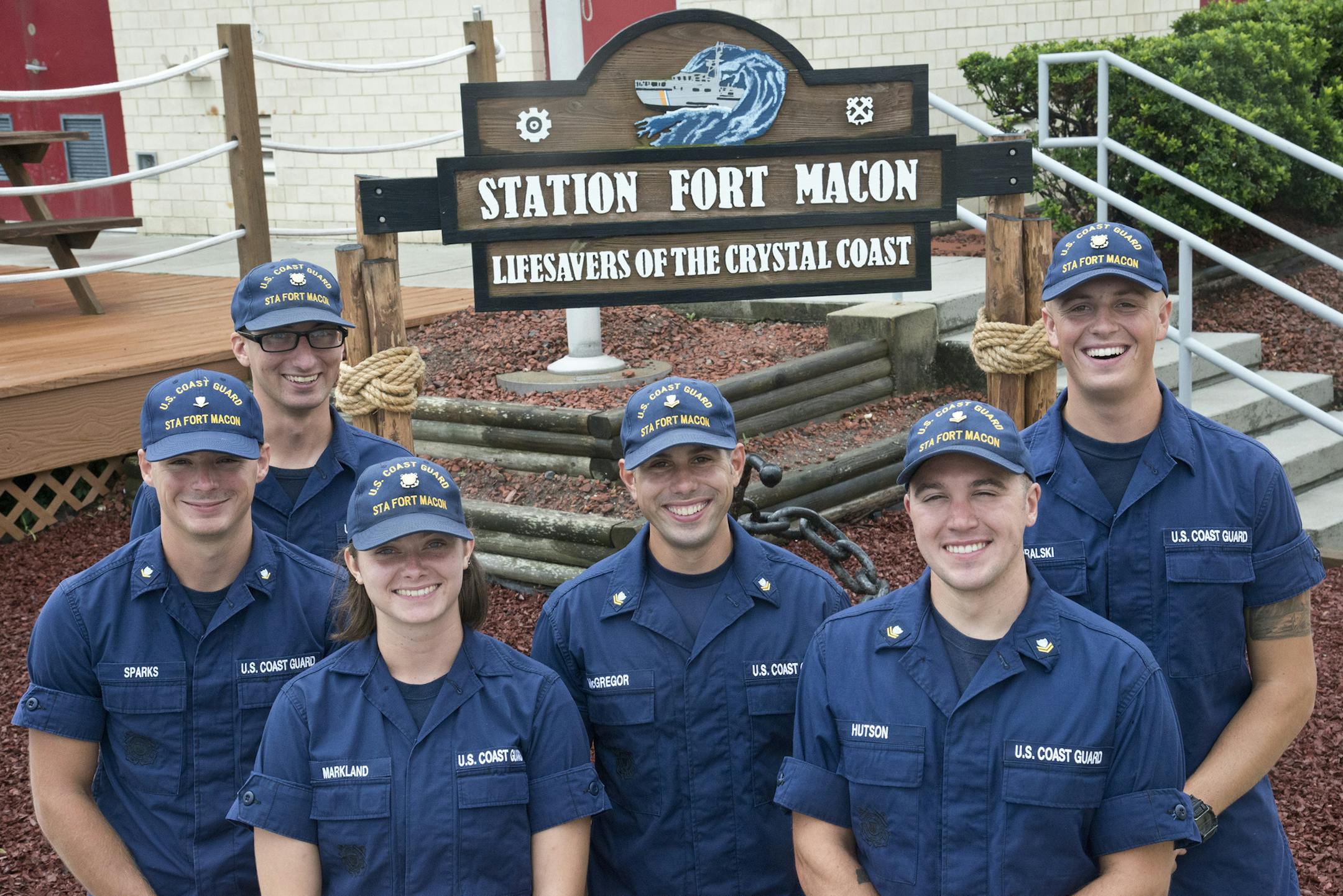 From left, Petty Officer 3rd Class Michael Sparks and Fireman Samuel Ragsdale pose with their rescuers, Fireman Jordan Markland, Petty Officer 2nd Class Tyler McGregor, Petty Officer 2nd Class Zane Hutson and Seaman Crewe Goralski, days after an incident in which two divers were stranded eight miles off Atlantic Beach. (Petty Officer 2nd Class Nate Littlejohn/U.S. Coast Guard)