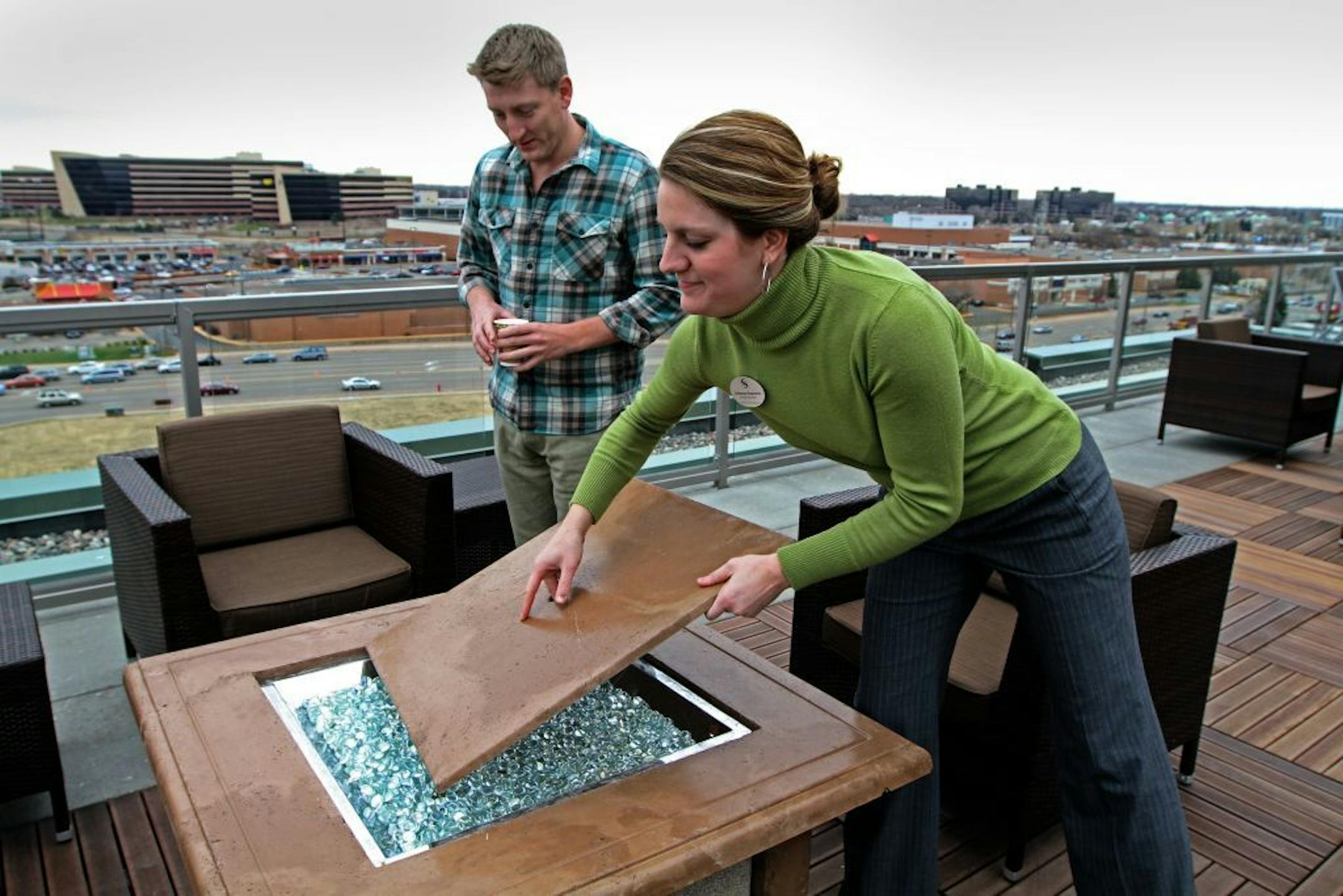 Genesee Apartments Asistant Manager Catherine Ragozzino gave John Stielow, of Wayzata a tour ot the new Genesee apartments in Bloomington on 11/2/12. Ragozzino was showing Stielow the built-in fireplace on the roof terrace.