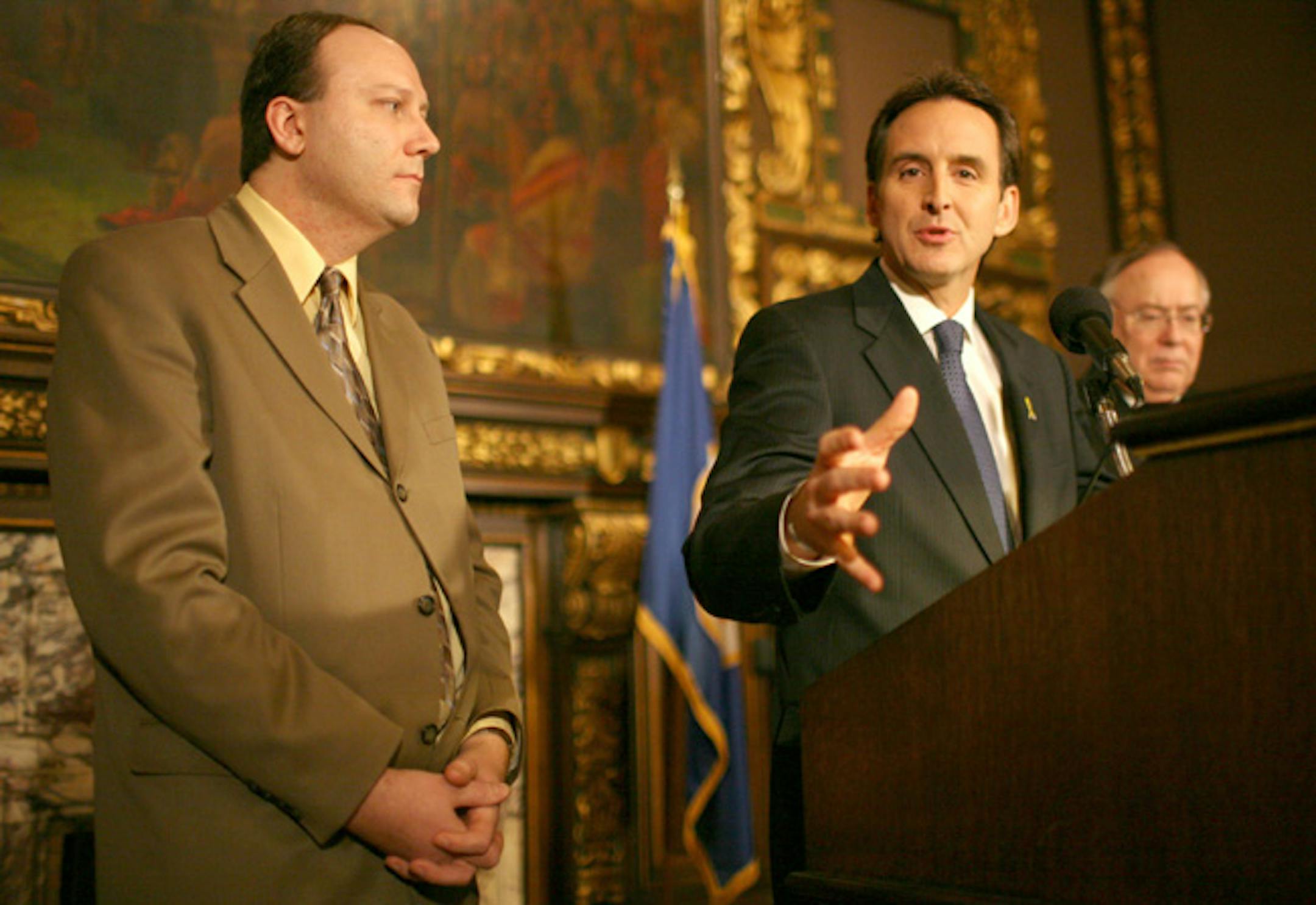 Gov. Tim Pawlenty, flanked by House Minority Leader Marty Seifert, left, and Senate Minority Leader David Senjem, lashed out at DFL legislators during a Tuesday news conference for overriding his veto of the transportation funding bill on Monday.