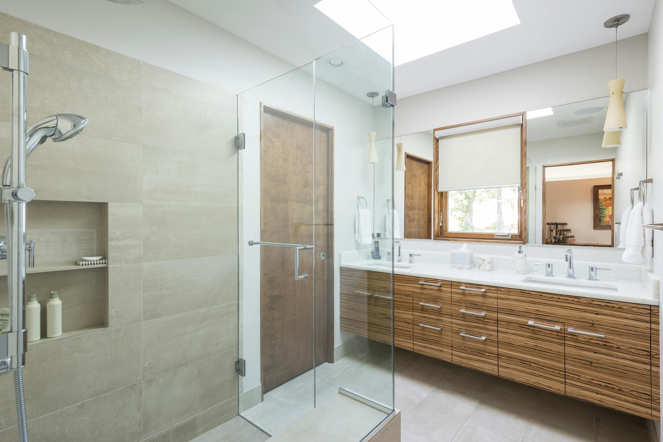 The spa-style master bathroom has a zebrawood floating vanity.