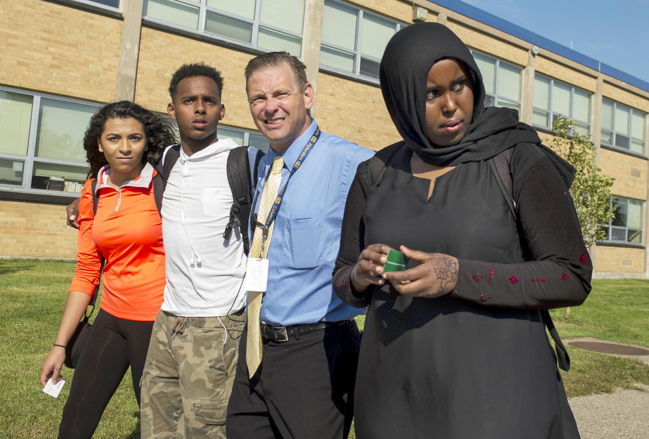 At Columbia Heights H.S., students Sherouk Mohamed,17,(orange), Karim Muse,17,(white), and Khadra Mohamed,18(black) walked out in solidarity against a school board member's anti-muslim comments. Principal Dan Wroblewski came out to lead the students back to class. He also led the walkout in solidarity with the students. ]Richard Tsong-Taatarii/rtsong-taatarii@startribune.com ORG XMIT: MIN1509161055421802