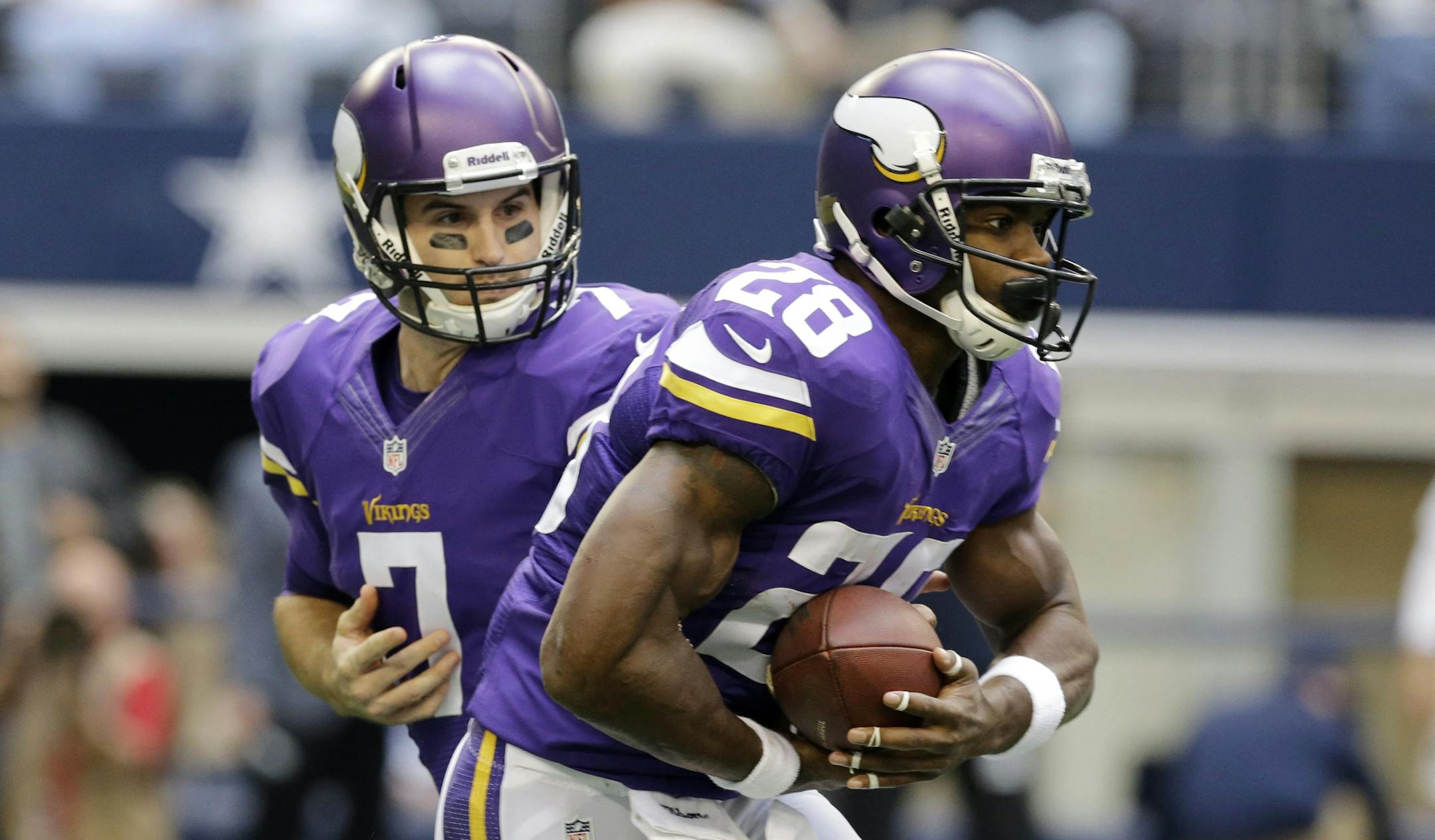 Minnesota Vikings quarterback Christian Ponder (7) hands the ball off to Adrian Peterson (28) in the first half of an NFL football game, Sunday, Nov. 3, 2013, in Arlington, Texas. (AP Photo/Nam Y. Huh) ORG XMIT: MIN2013110312184521