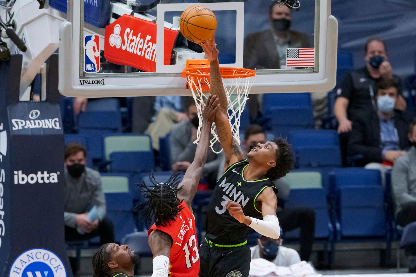 Minnesota Timberwolves forward Jaden McDaniels (3) blocks the shot of New Orleans Pelicans guard Kira Lewis Jr. (13) during the first half of an NBA basketball game in New Orleans, Thursday, March 11, 2021. (AP Photo/Matthew Hinton)