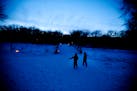 Two kids enjoyed their walk with their family during an outing on candlelit trails at Fort Snelling State Park.
