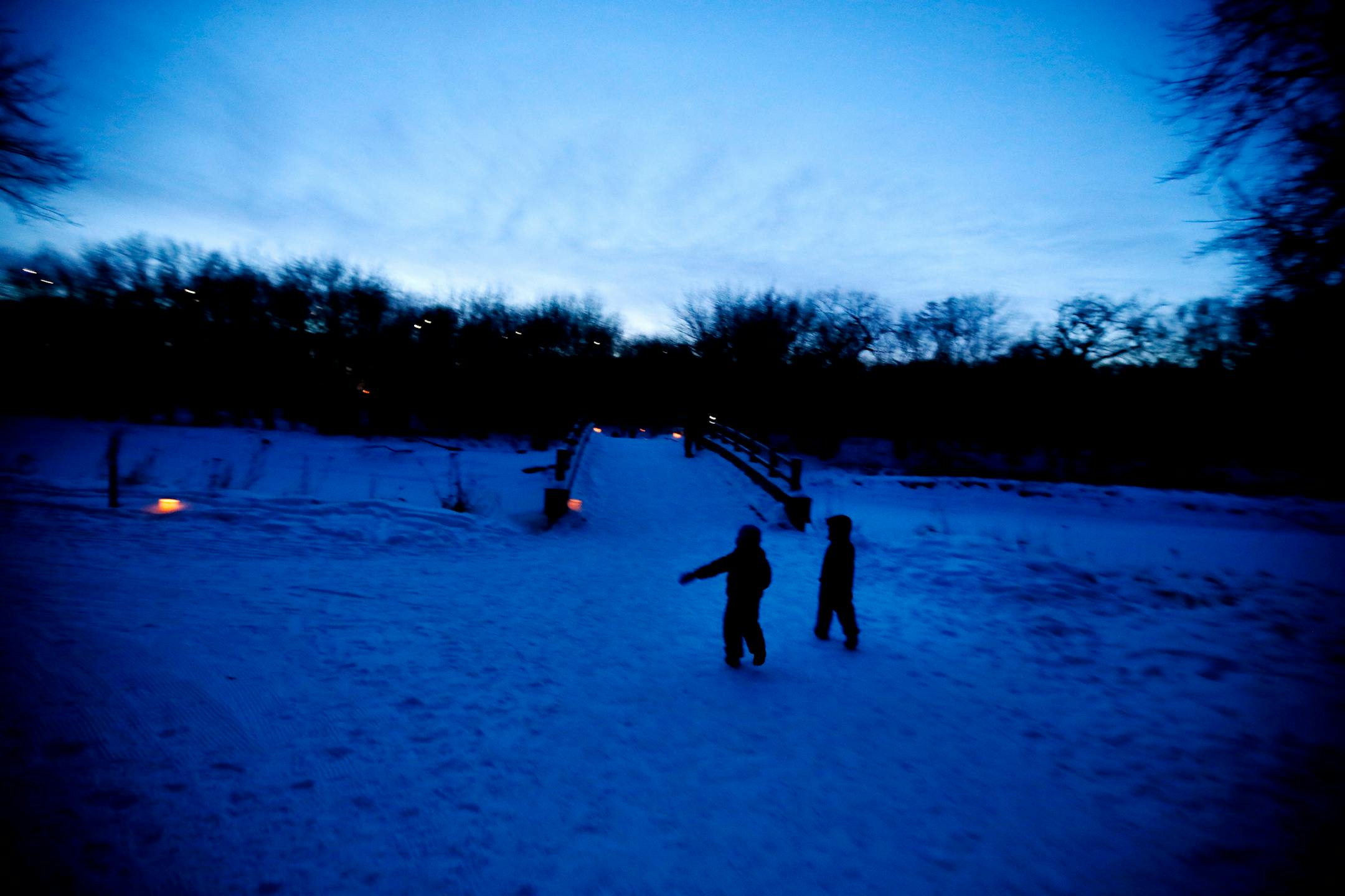 Two kids enjoyed their walk with their family during an outing on candlelit trails at Fort Snelling State Park.