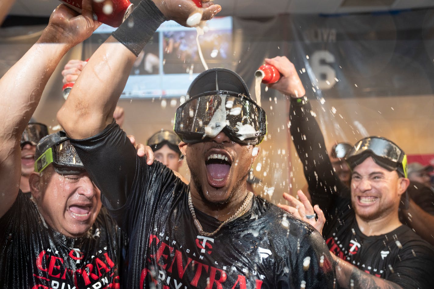 Twins players and staff, including Jorge Polanco, celebrated with beer and champagne in the clubhouse after clinching the American League Central title Friday.