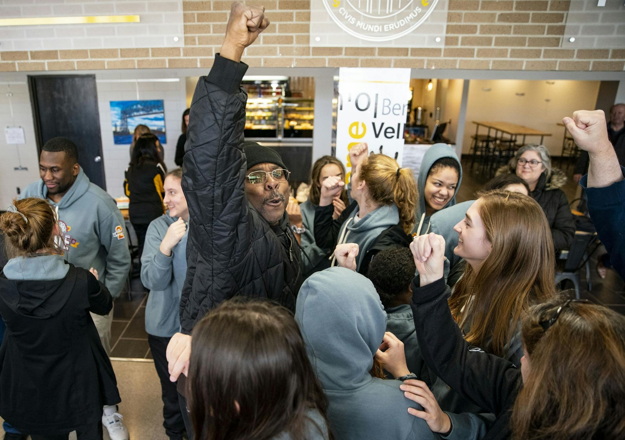 Aaron Kirk, the father of Duluth Marshall guard Grace Kirk, led the girl's basketball team in one last chant in the main lobby of the Marshall school on Friday.