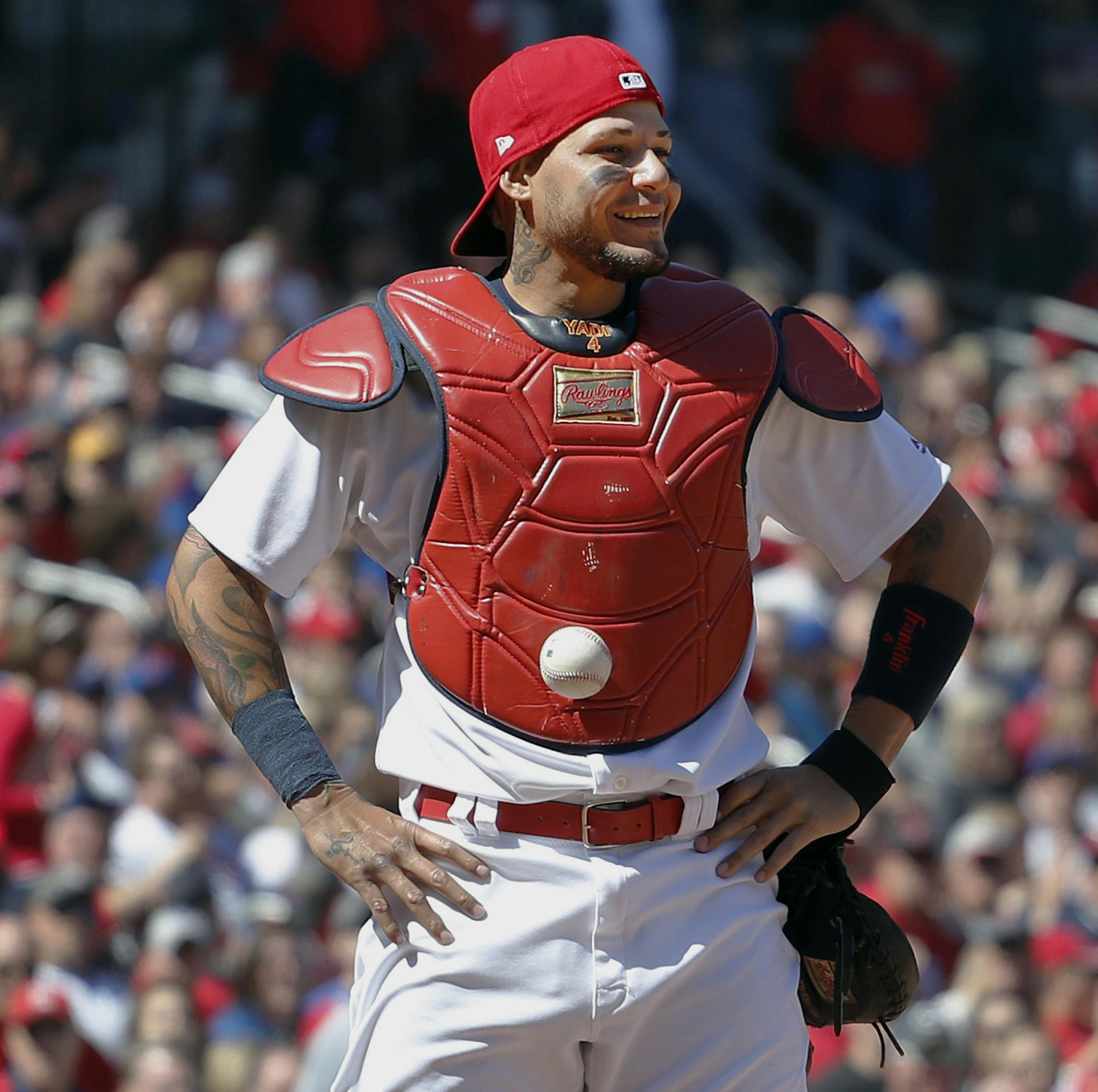 St. Louis Cardinals catcher Yadier Molina stands with his hands on his hips as a ball is somehow stuck to his chest protector during the seventh inning of a baseball game against the Chicago Cubs on Thursday, April 6, 2017, in St. Louis. The ball was stuck to Molina's chest protector on a dropped third strike allowing the Cubs' Matt Szczur to reach first base when Molina couldn't find the ball. (AP Photo/Jeff Roberson)