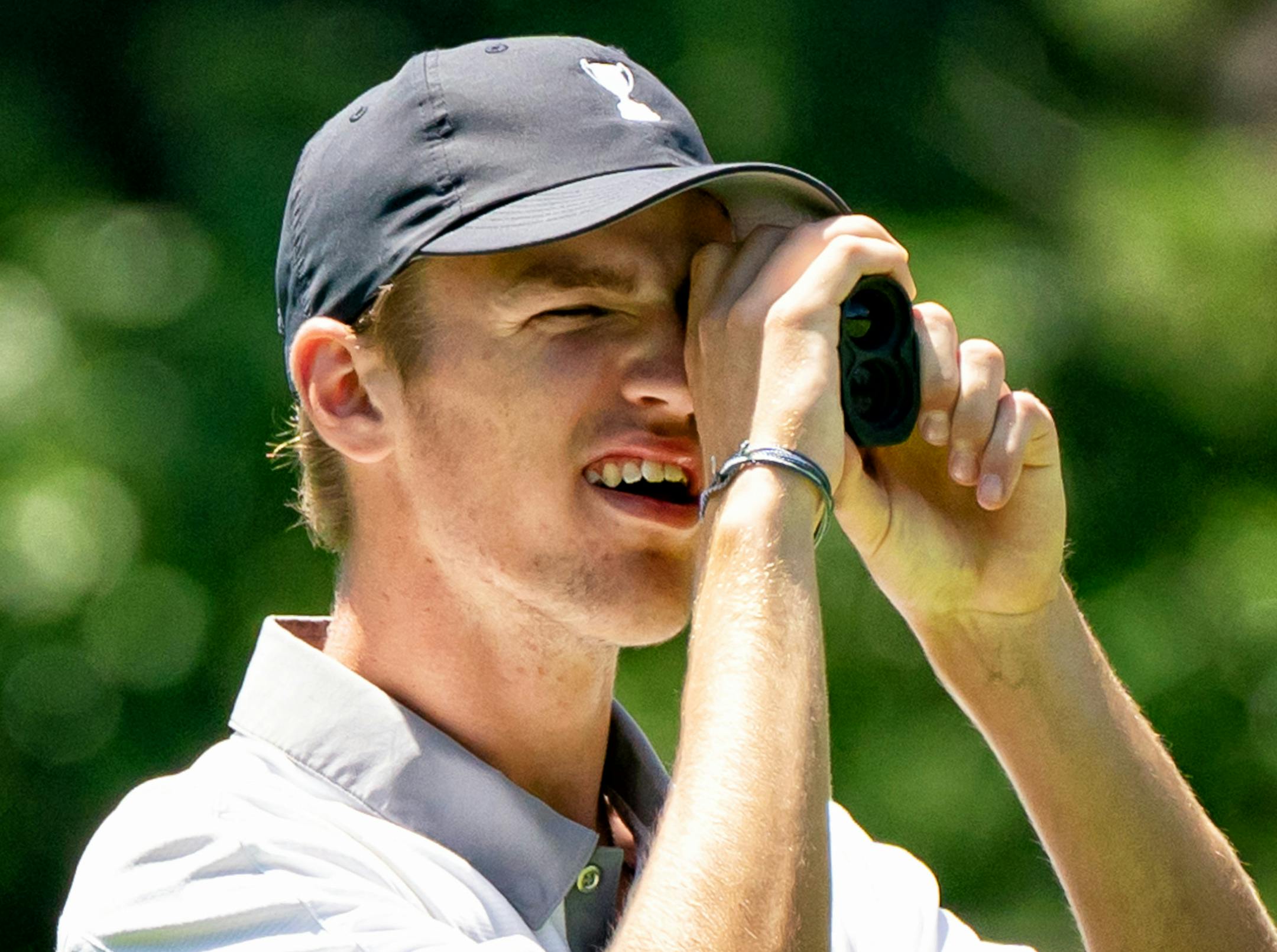 Tristan Nelko of Wayzata checked his yardage on the second day of the Class 3A boys' tournament at Bunker Hills. Nelko won by four strokes.