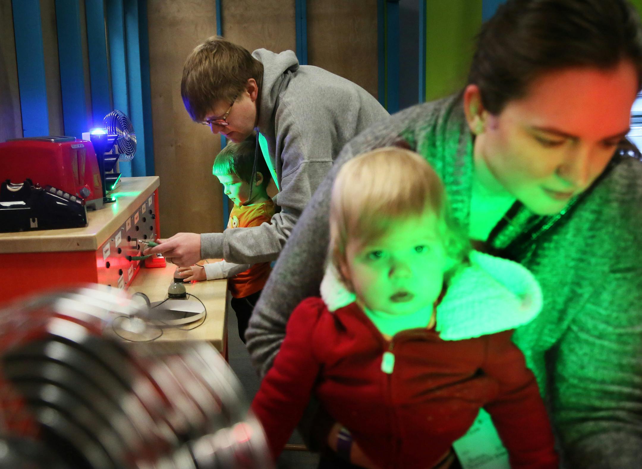 The Works Museum exploded with activity during the annual celebration of National Engineers Week Saturday, Feb. 28, 2015, in Bloomington, MN. Here, parents Nick Kleinjen, second from left, and his wife Jen, right, exposed their children Lucas, 4, left, and Haley, 1 1/2, and her twin Sophia, not pictured, to some different sensors from things like a radio, fan or telephone at the event.](DAVID JOLES/STARTRIBUNE)djoles@startribune.com Join in the fun as our Museum explodes with activity during our