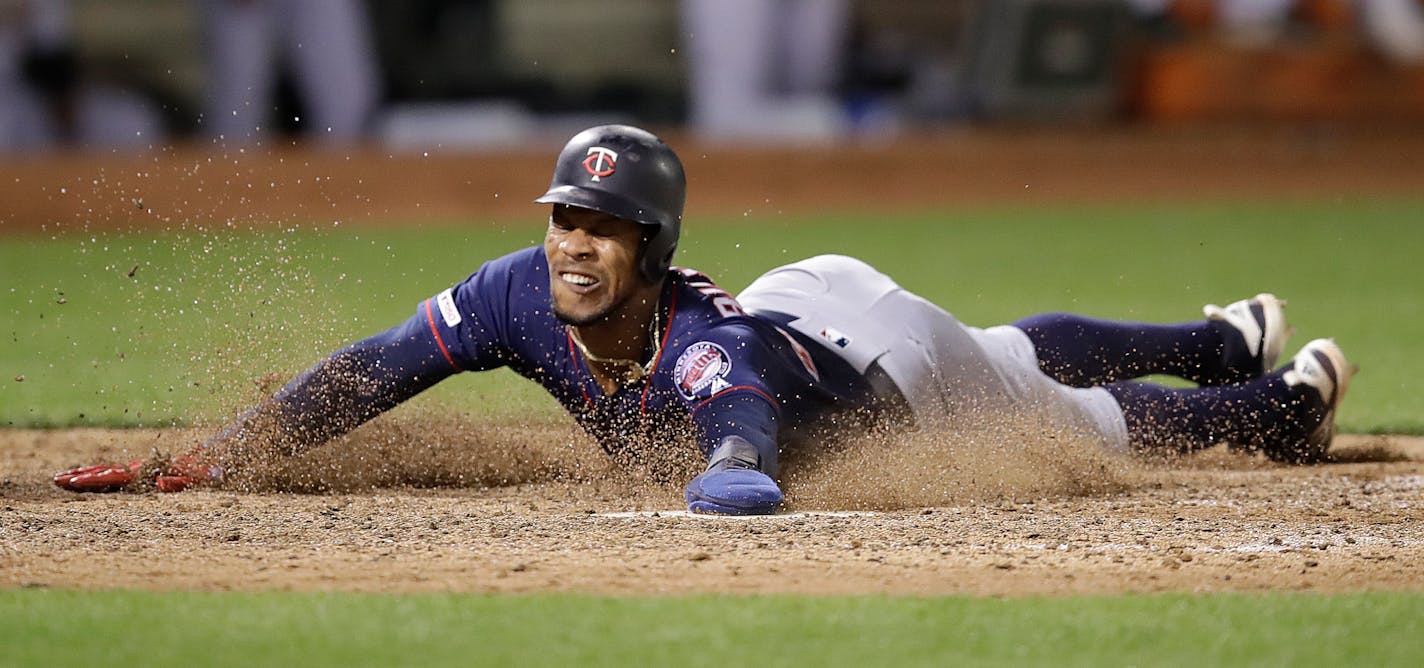 Byron Buxton slides to score against the Athletics in the 12th inning on July 3.