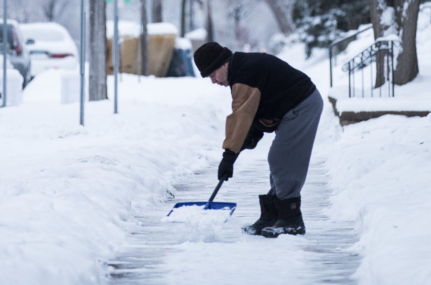 A man shovels the sidewalk on S. 8th Street near Riverside Avenue in Minneapolis, where property owners are responsible for clearing sidewalks. Crystal is looking to take over snow removal on all its sidewalks as early as next winter. ] (Leila Navidi/Star Tribune) leila.navidi@startribune.com