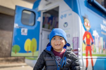 Freddy Tirado jumped in line to get ice cream as he visited Hennepin Healthcare’s new mobile pediatric van outside the hospital in Minneapolis.