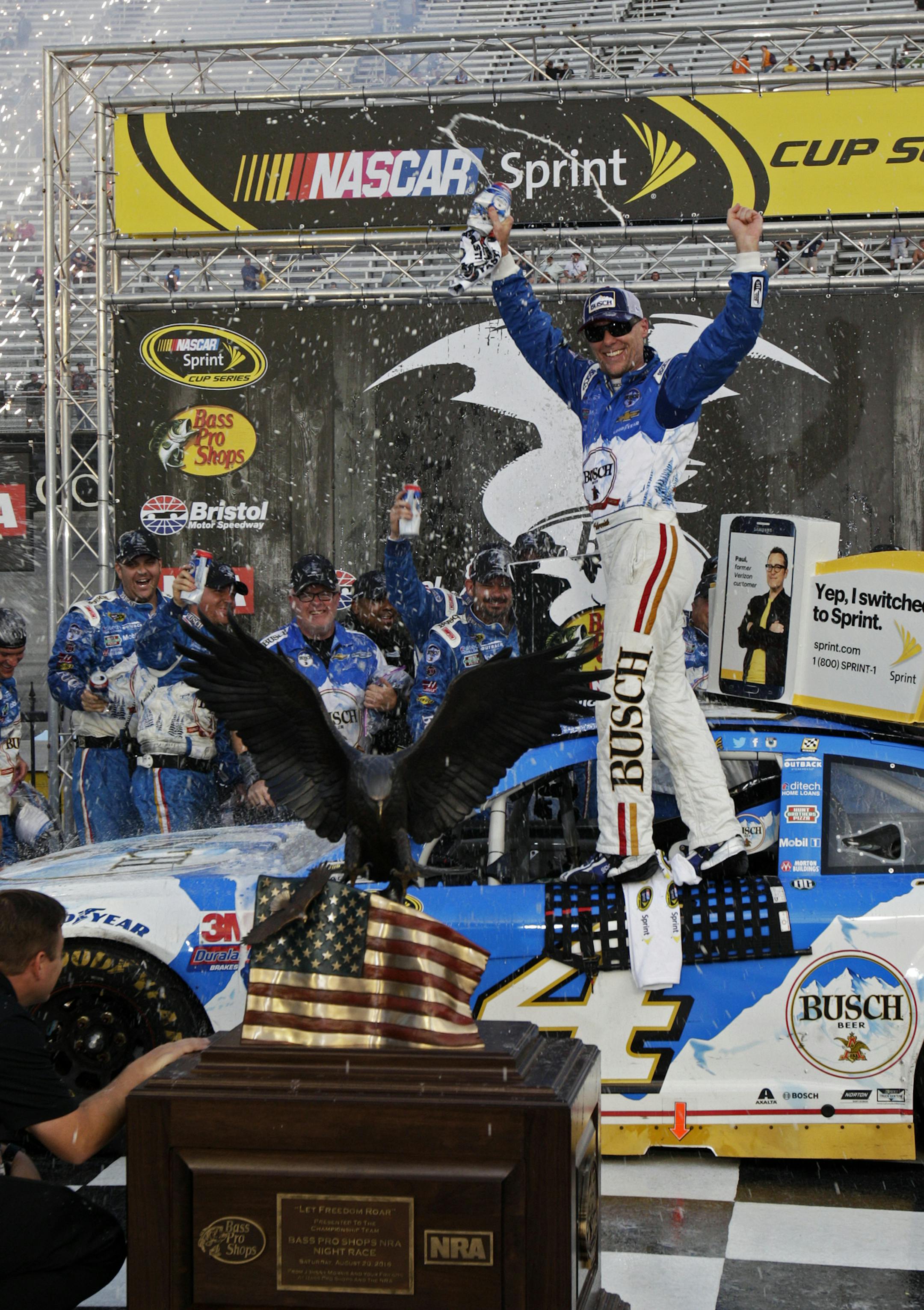 Kevin Harvick celebrates after winning a NASCAR Sprint Cup Series auto race, Sunday, Aug. 21, 2016 in Bristol, Tenn. The race was delayed Saturday night due to severe weather. (AP Photo/Wade Payne)
