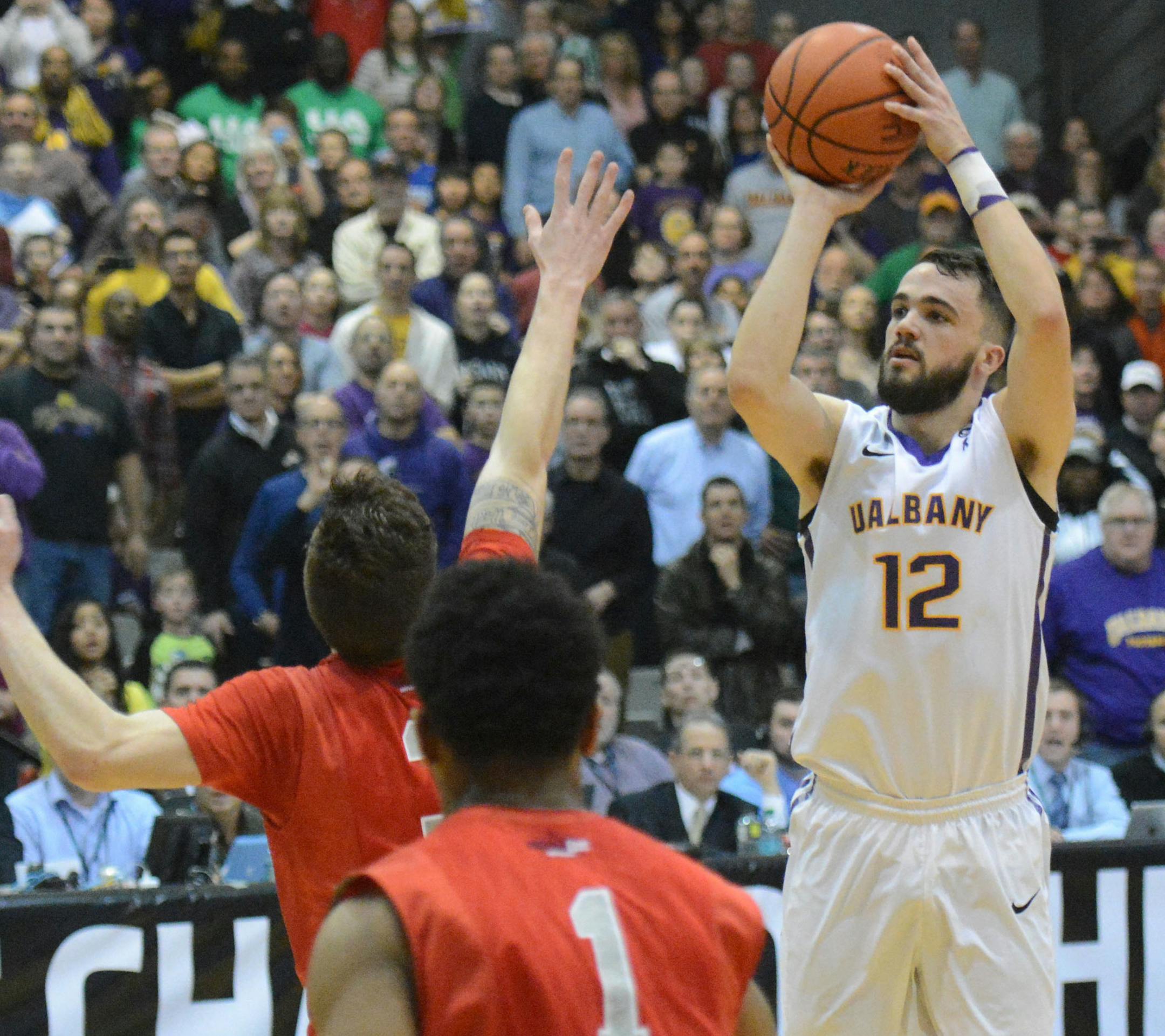 Albany's Peter Hooley, right, shoots the game-winning basket against Stony Brook late in the second half of an NCAA college basketball game in the America East Conference tournament championship in Albany, N.Y., on Saturday, March 14, 2015. Albany won, 51-50. (AP Photo/The Daily Gazette, Patrick Dodson) TROY, SCHENECTADY; SARATOGA SPRINGS; ALBANY AND AMSTERDAM OUT