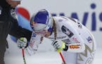 United States' Lindsey Vonn grimaces in pain after getting to the finish area after completing an alpine ski, women's World Cup super-G, in St. Moritz