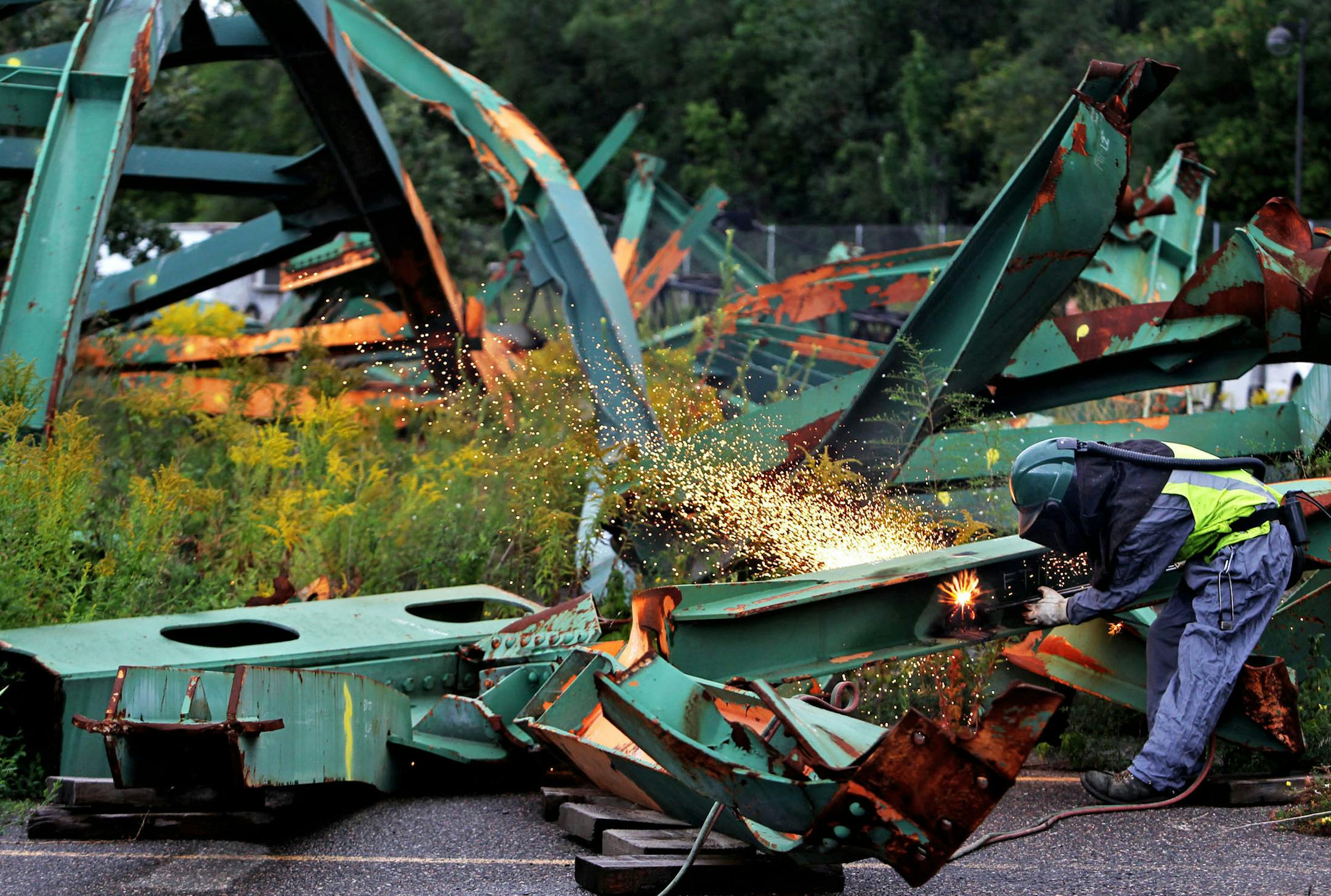 In this Sept. 7, 2010 file photo, the remains of the fallen 35W bridge that had been stored along East River Road were about to be moved to a new location in the east metro near Afton.