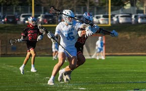 Defenders seldom slide off Bloomington Jefferson's Kevin Graff (16) when he quarterbacks his team’s offensive sets, but he makes it a point of empha