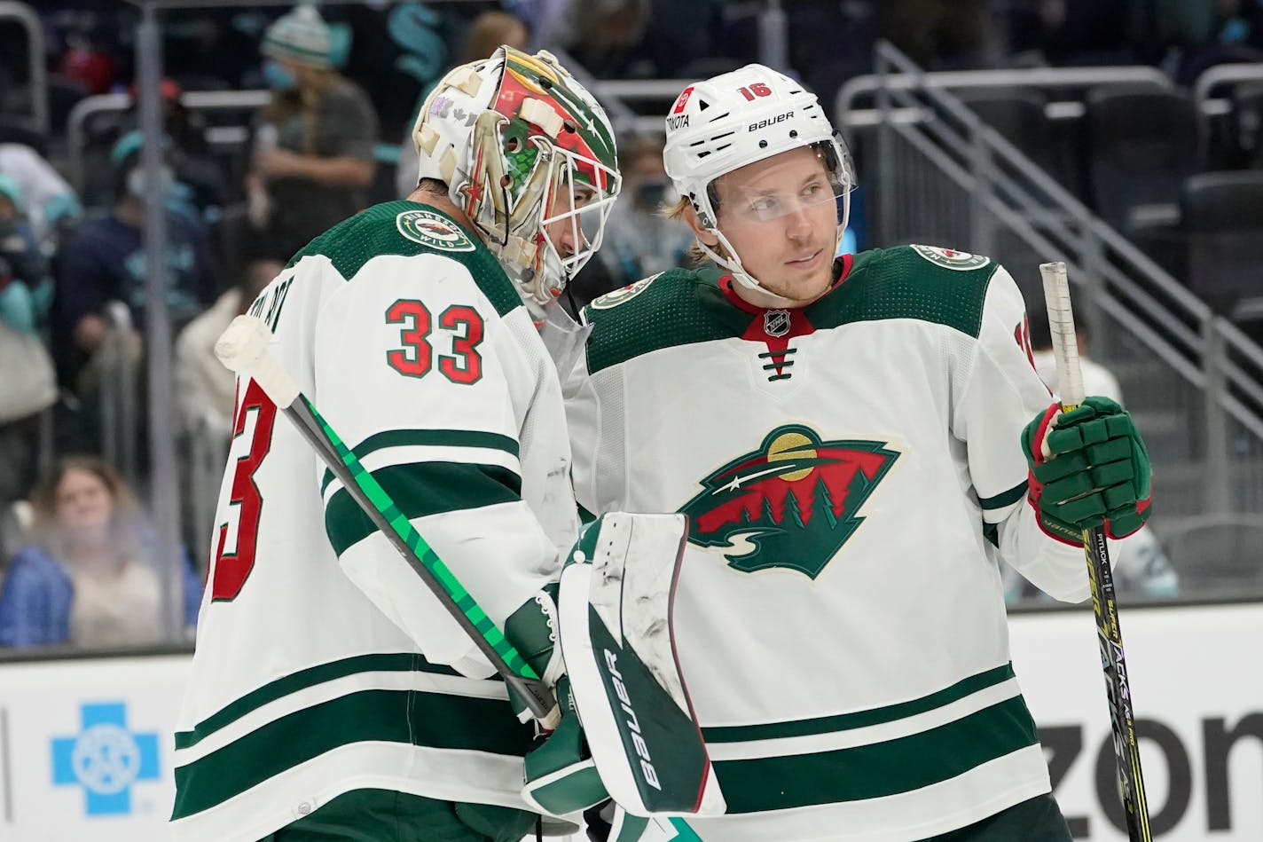 Minnesota Wild goaltender Cam Talbot (33) greets center Rem Pitlick, right, after the Wild defeated the Seattle Kraken 4-2 in an NHL hockey game, Saturday, Nov. 13, 2021, in Seattle. Pitlick had a hat trick. (AP Photo/Ted S. Warren)