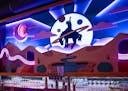Behind the bar at Fool Me Once in Minneapolis' Uptown is a changing neon light installation depicting a cowboy.