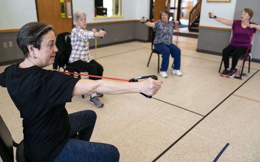 Volunteer Jorja DuFresne, left, did arrow arm stretches as she taught a Senior Corps workout class called Fit and Strong! at Fuller Park building in Minneapolis, Minn., on Friday, February 22, 2019. The class is designed to do aerobic, weight lifting and other activities to learn about how to prevent injuries from falling. ] RENEE JONES SCHNEIDER &#xa5; renee.jones@startribune.com