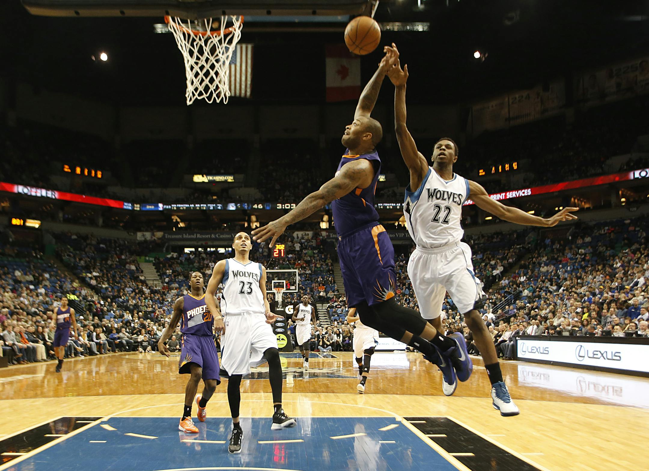 Minnesota Timberwolves forward Andrew Wiggins (22) fouls Phoenix Suns forward P.J. Tucker (17) from behind during a breakaway late in the second quarter.