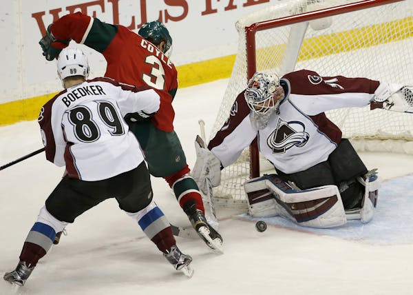 Colorado Avalanche goalie Calvin Pickard (31) stops a shot by Minnesota Wild center Charlie Coyle (3) in front of Avalanche left wing Mikkel Boedker (