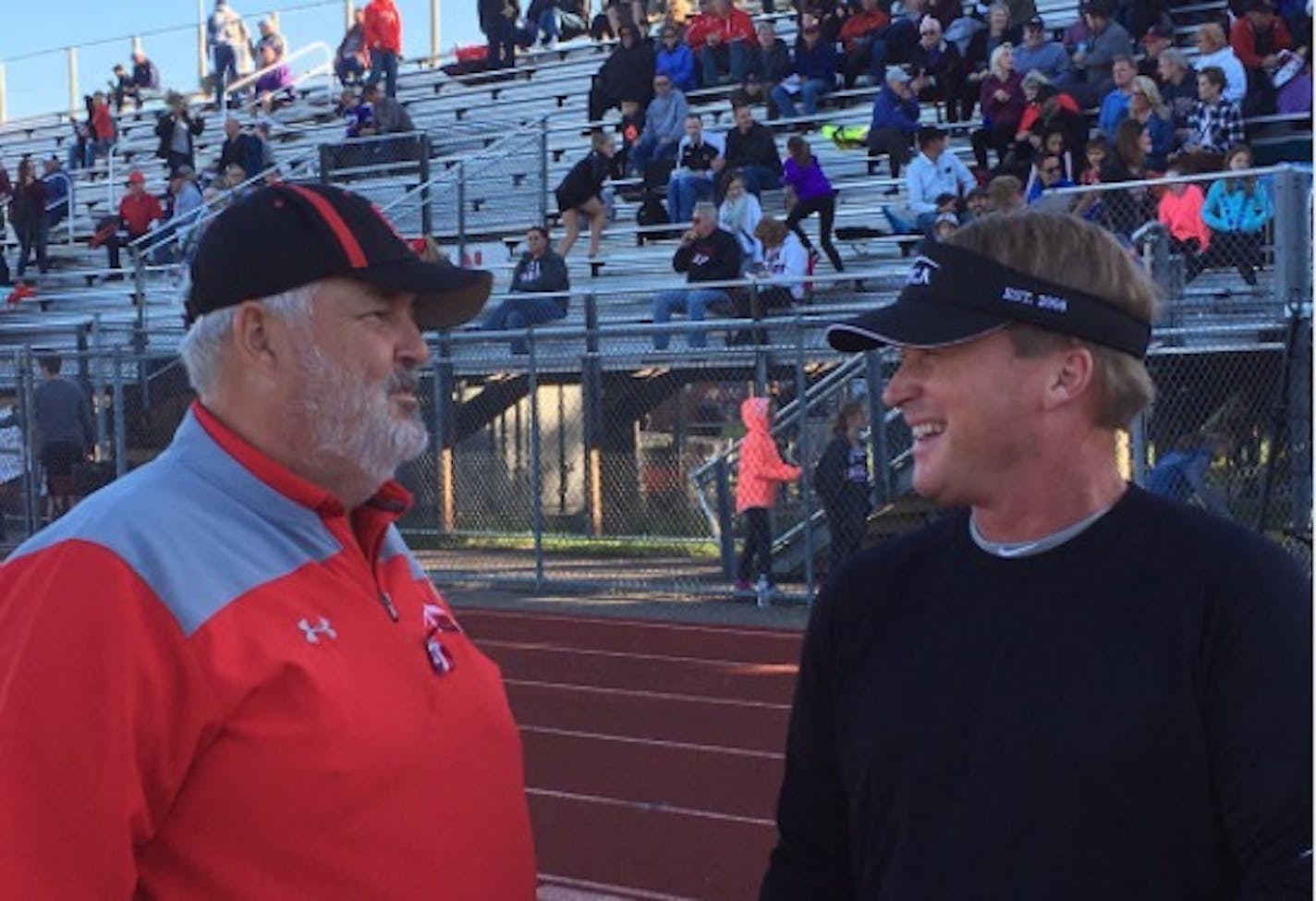 Jon Gruden, with Eden Prairie football coach Mike Grant on Friday night.