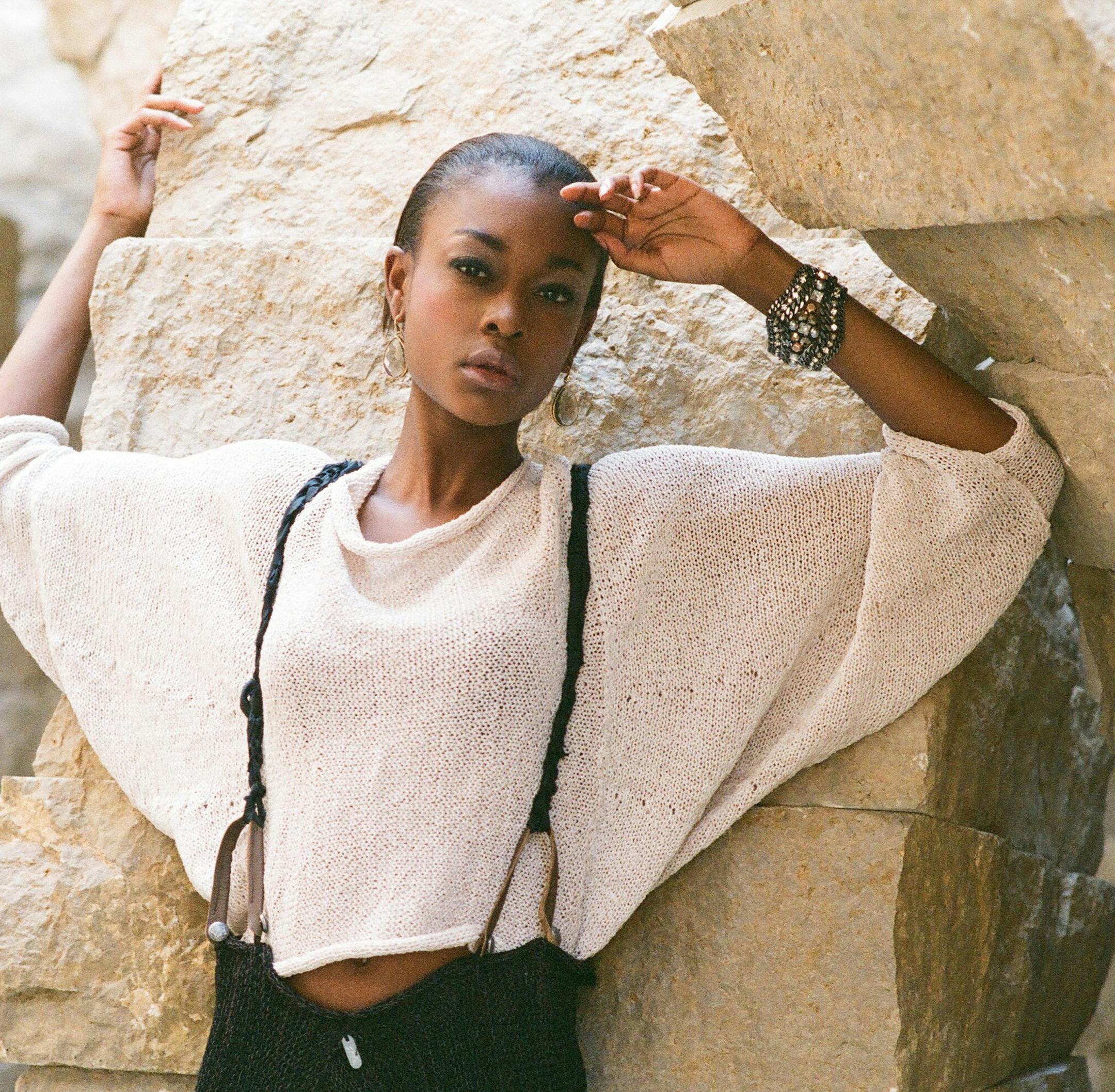 Tara stands in 'Stone Sea,' 2012, by Andy Goldsworthy. She wears a cream cropped sweater with dolman sleeves ($270) and loose skirt with leather straps and hand crocheted suspenders ($250), both at Skif International, 314-773-4401; black Pretty Polly tights ($25) at Macy's, www.macys.com; smoky Serenity Stone drop earrings ($49) and Kahlo bracelet ($89) both at Stella & Dot, www.stelladot.com. (Erik M. Lunsford/St. Louis Post-Dispatch/MCT) ORG XMIT: 1143577