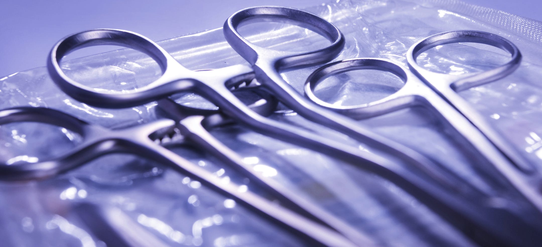 Surgical instruments lying on top of a sterile autoclave bag.