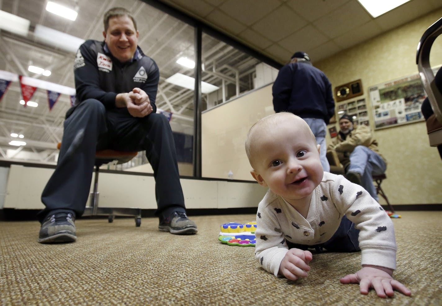 U.S. Olympic curler John Shuster chilled with son Luke during a break from the ice earlier this month at the Duluth Curling Club.