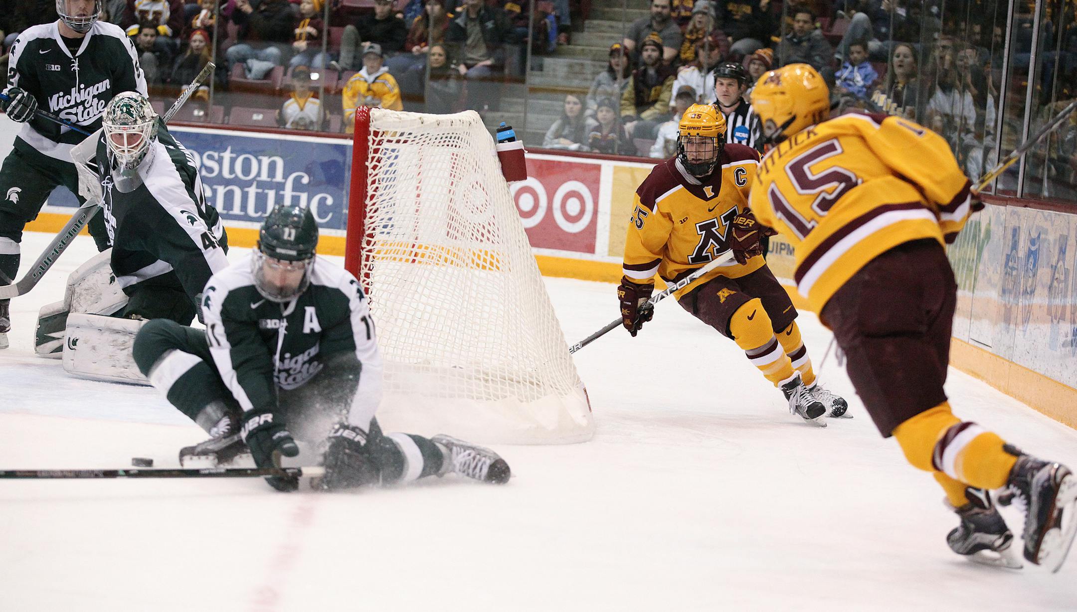 Michigan State Spartansí Rhett Holland (11) blocks Minnesota Gophersí Rem Pitlick (15)'s shot in the first period. ] XAVIER WANG ï xavier.wang@startribune.com Game action from a Big Ten Menís hockey game between Minnesota Gophers and Michigan State Spartans on Saturday. March, 11. 2017. at Mariucci Arena on the grounds of University of Minnesota in Minneapolis.
