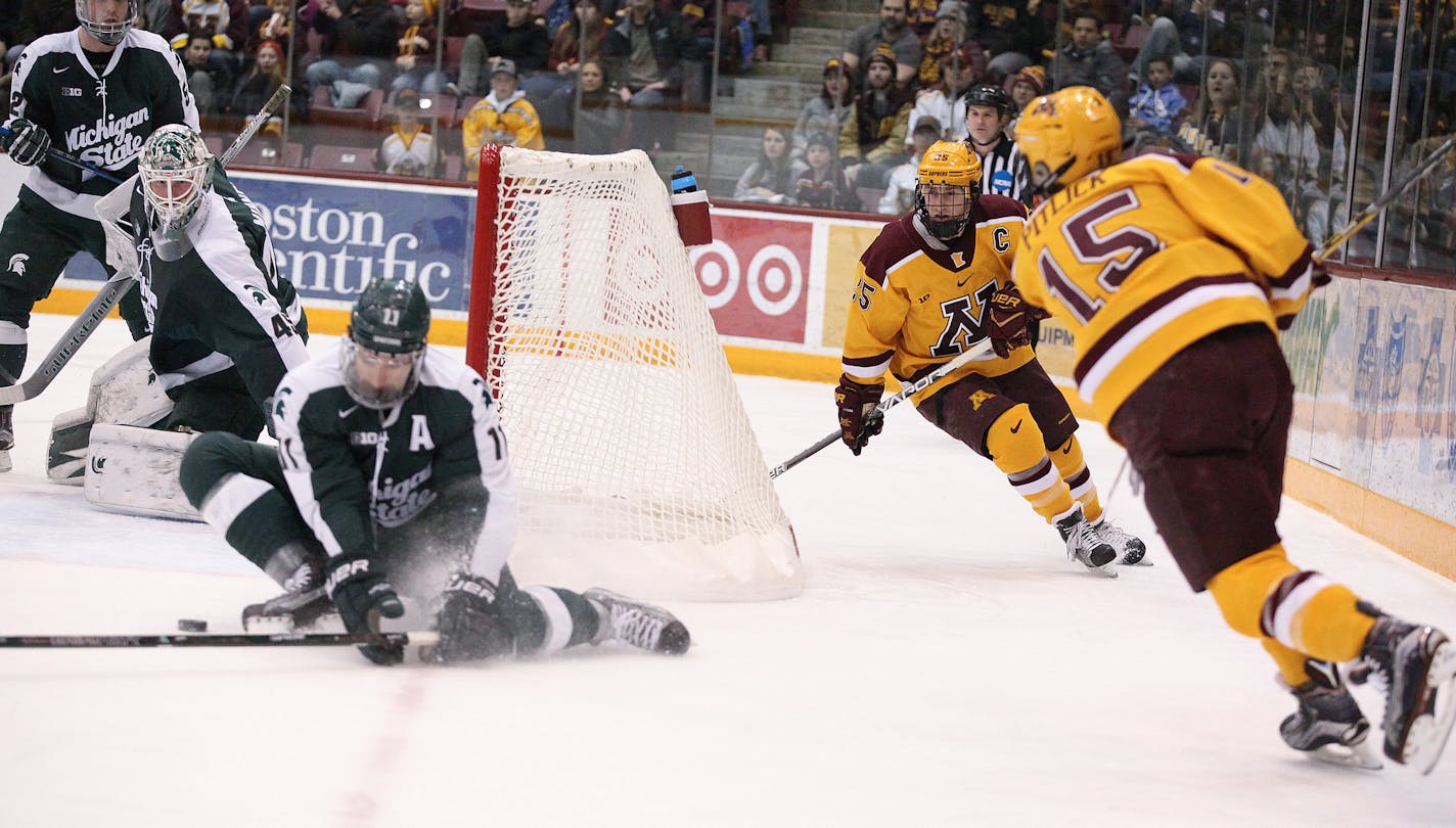 Michigan State Spartans&#xed; Rhett Holland (11) blocks Minnesota Gophers&#xed; Rem Pitlick (15)'s shot in the first period. ] XAVIER WANG &#xef; xavier.wang@startribune.com Game action from a Big Ten Men&#xed;s hockey game between Minnesota Gophers and Michigan State Spartans on Saturday. March, 11. 2017. at Mariucci Arena on the grounds of University of Minnesota in Minneapolis.