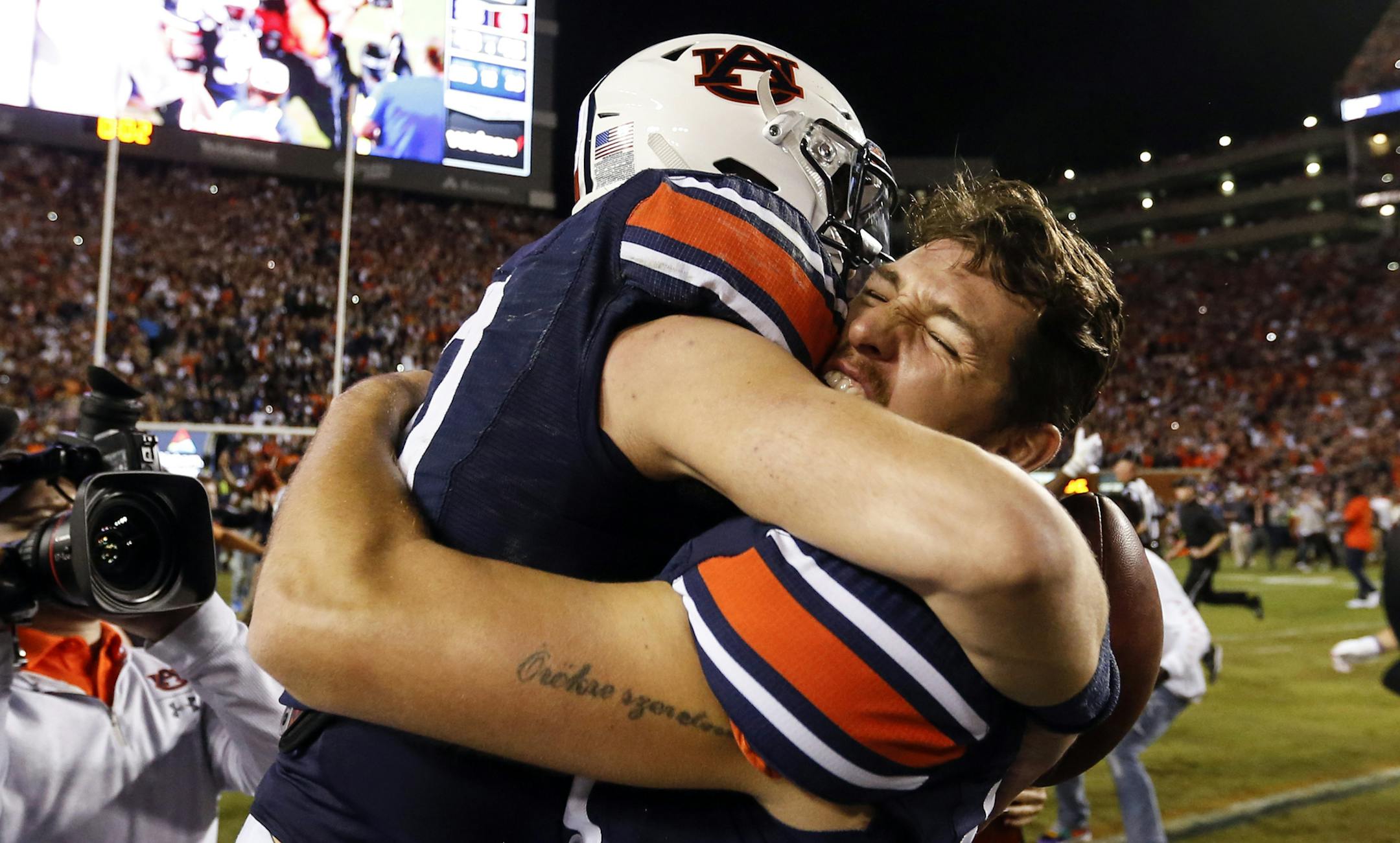 Auburn quarterback Bo Nix (10) celebrates with punter Arryn Siposs (90) after they defeated Alabama 48-45 in an NCAA college football game Saturday, Nov. 30, 2019, in Auburn, Ala. (AP Photo/Butch Dill)